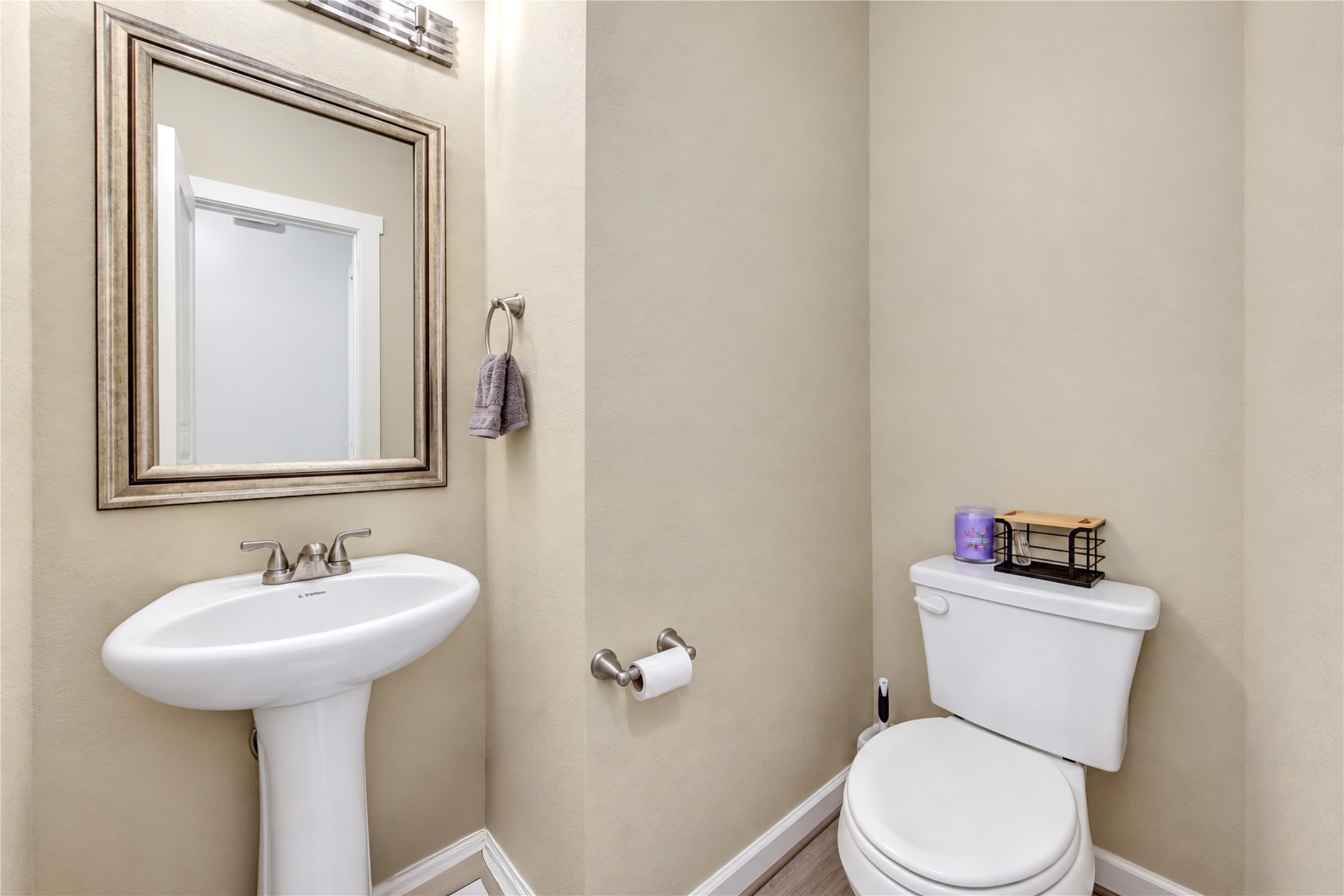 A conveniently located half bath featuring a pedestal sink and attractive finishes.
