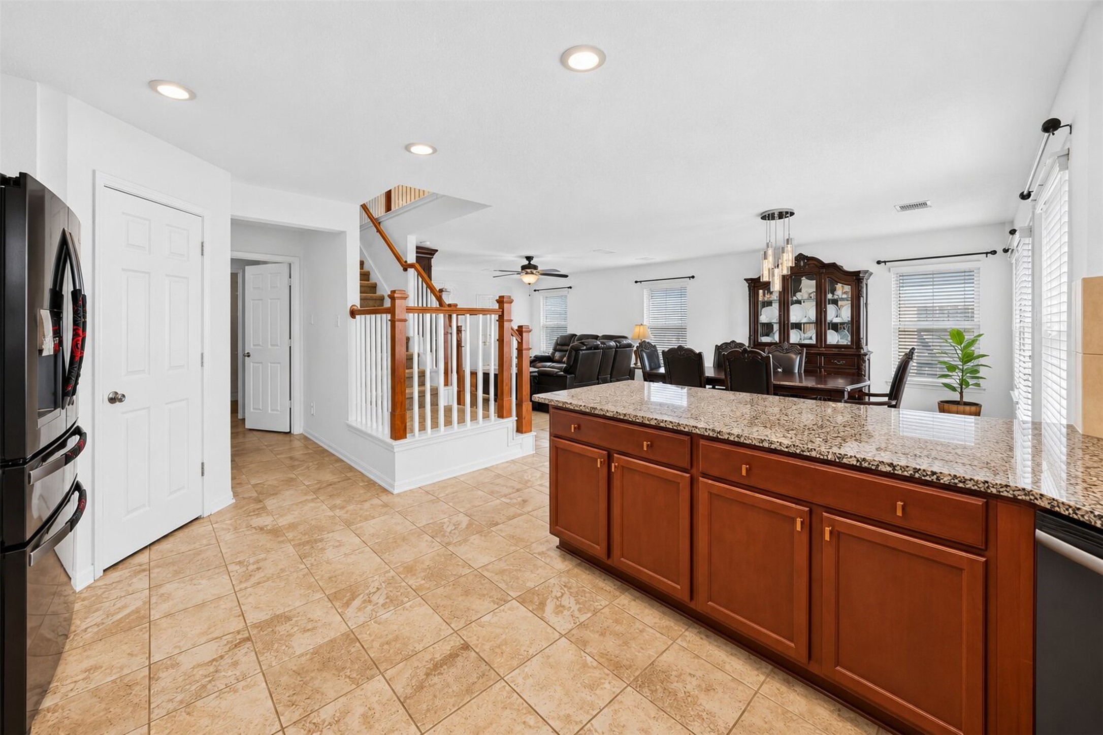 view from kitchen into dining room and staris leading to 2nd floor