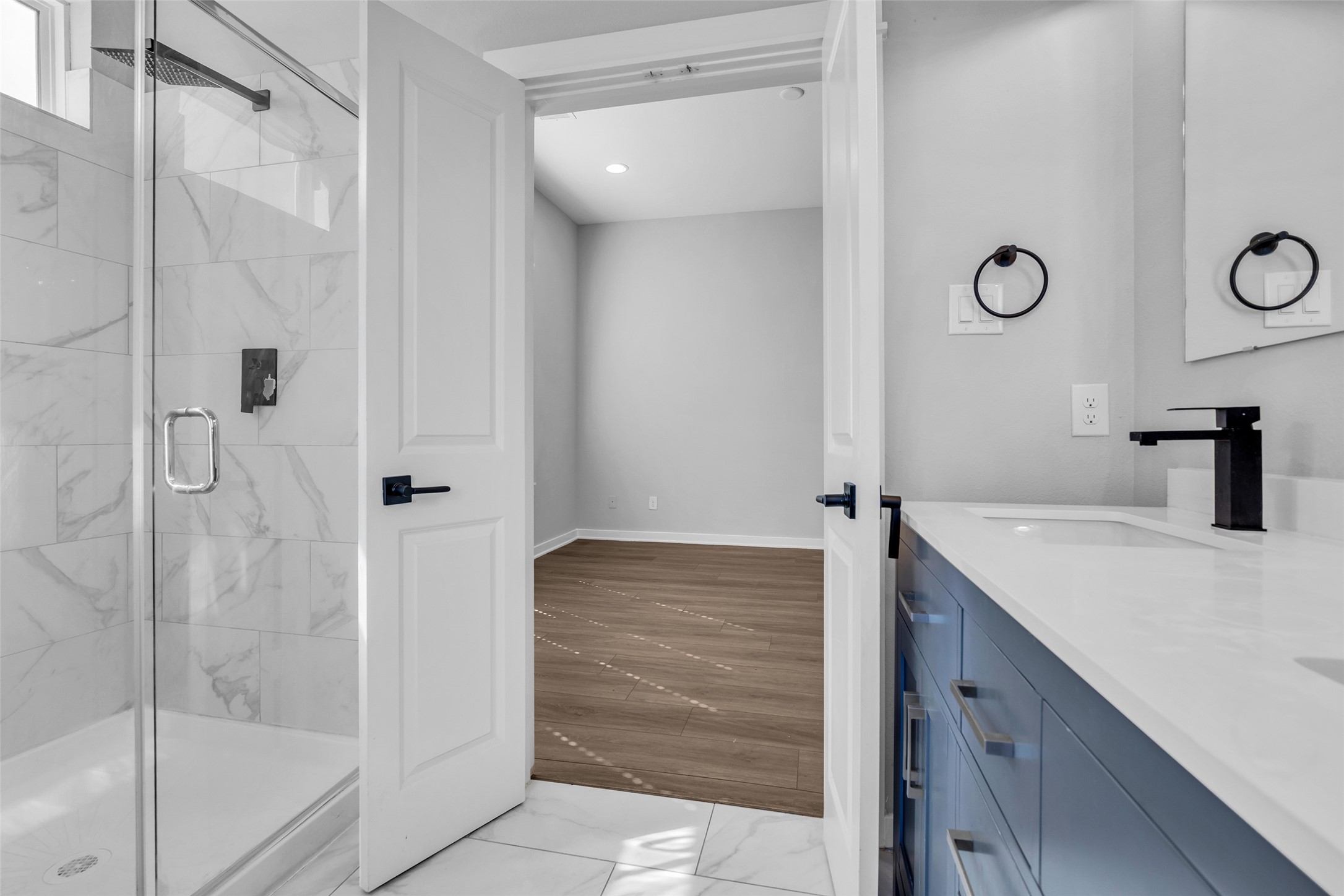 Start the day in the frameless glass shower with a rainfall showerhead for a spa-style feel.