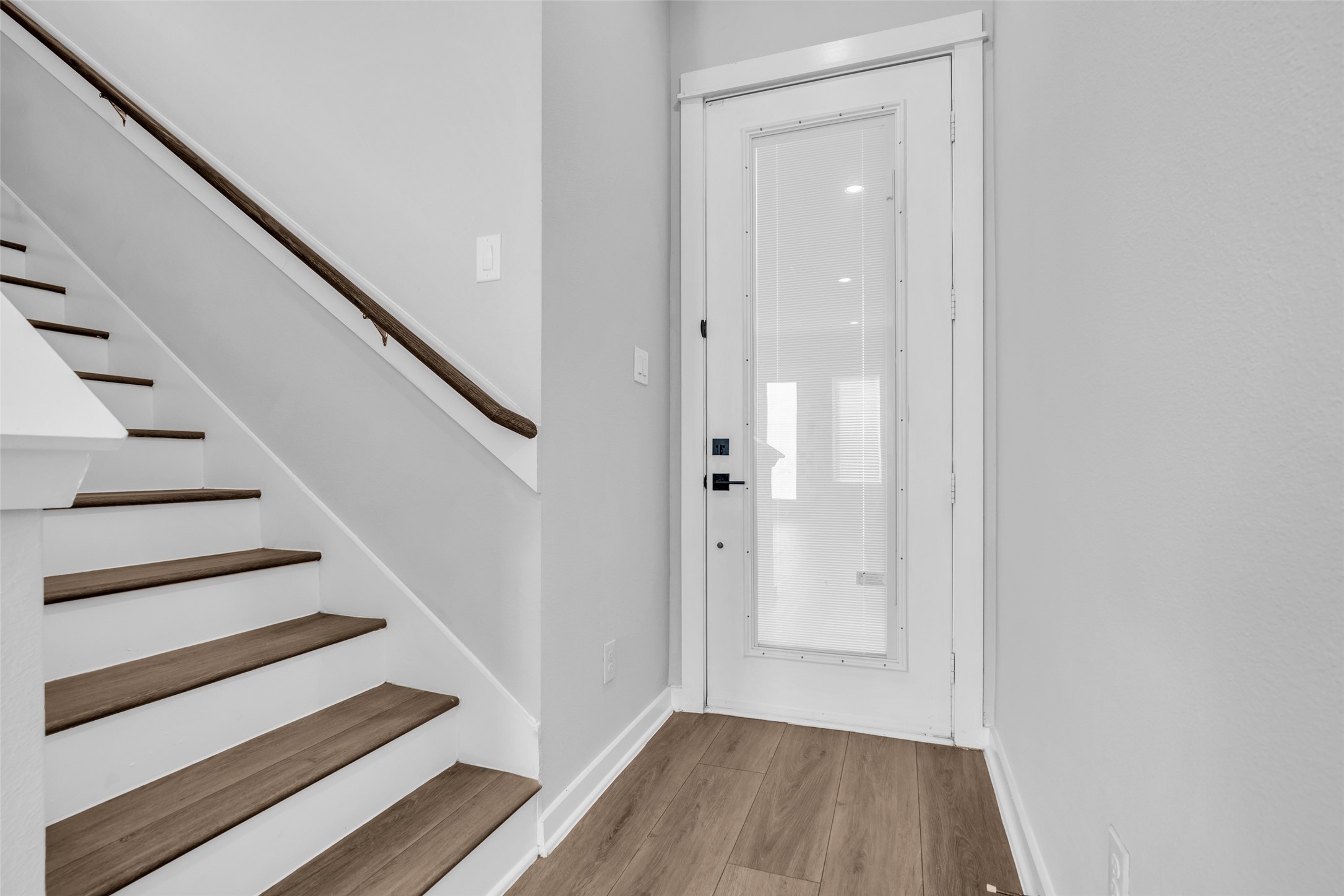 Step inside to wood-look plank floors and a staircase leading to all three bedrooms upstairs. Step inside to wood-look plank floors and a staircase leading to all three bedrooms upstairs.