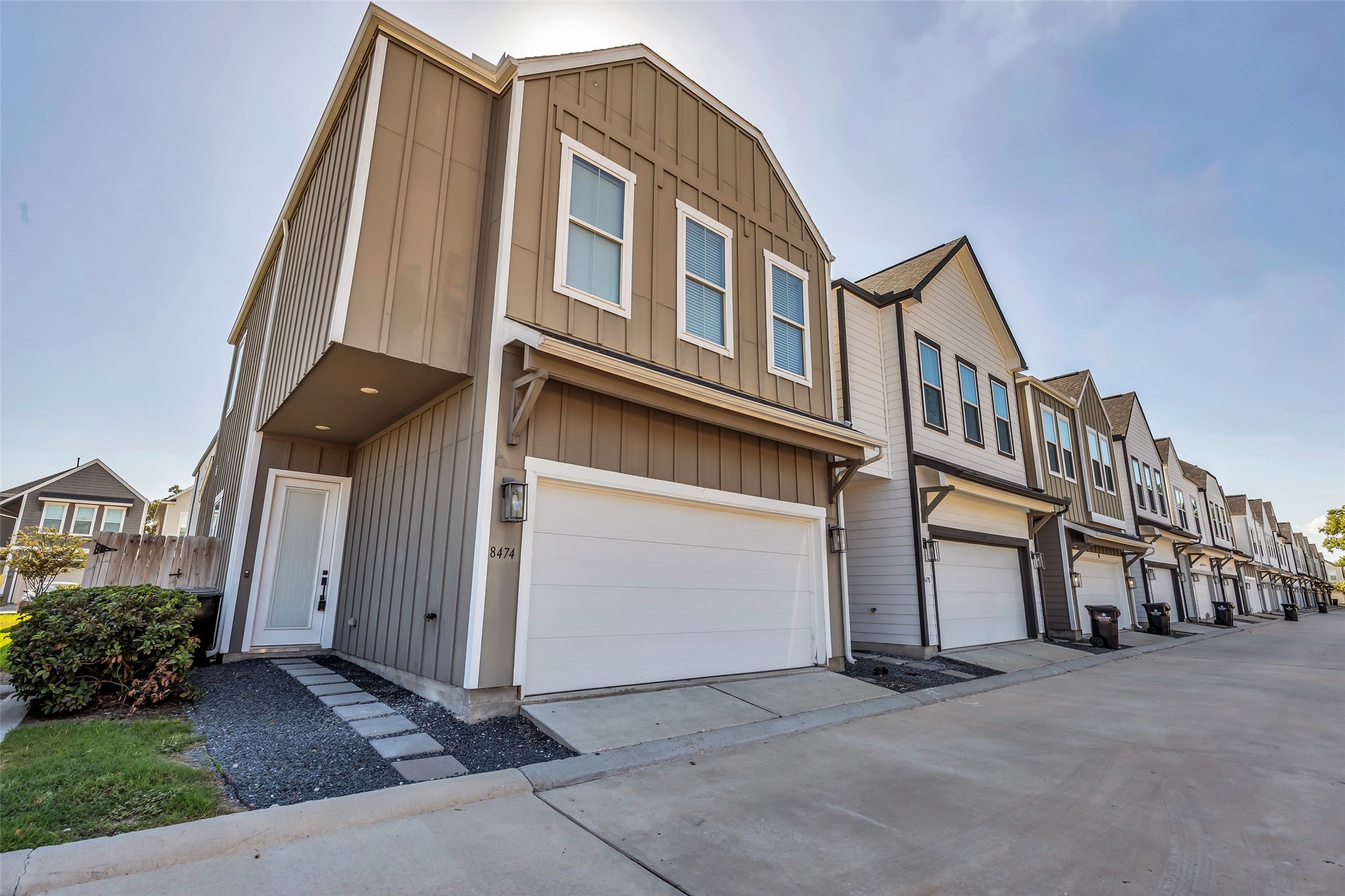 Welcome to 8474 Berry Green Ln, a 3 bedroom, 2.5 bathroom home in Houston. A crisp board-and-batten exterior, attached two-car garage and easy-care gravel landscaping.