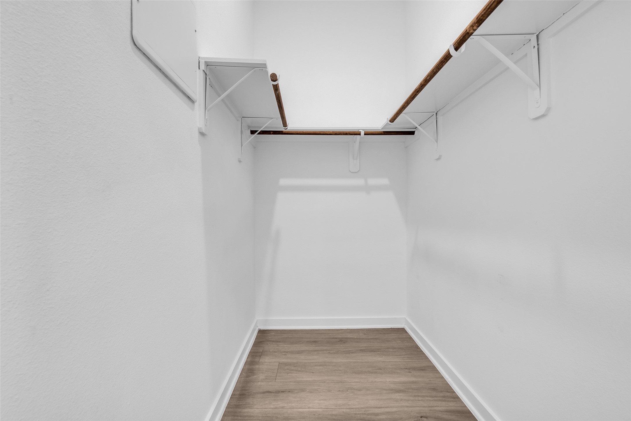 A walk-in closet that keeps wardrobes organized and out of sight.