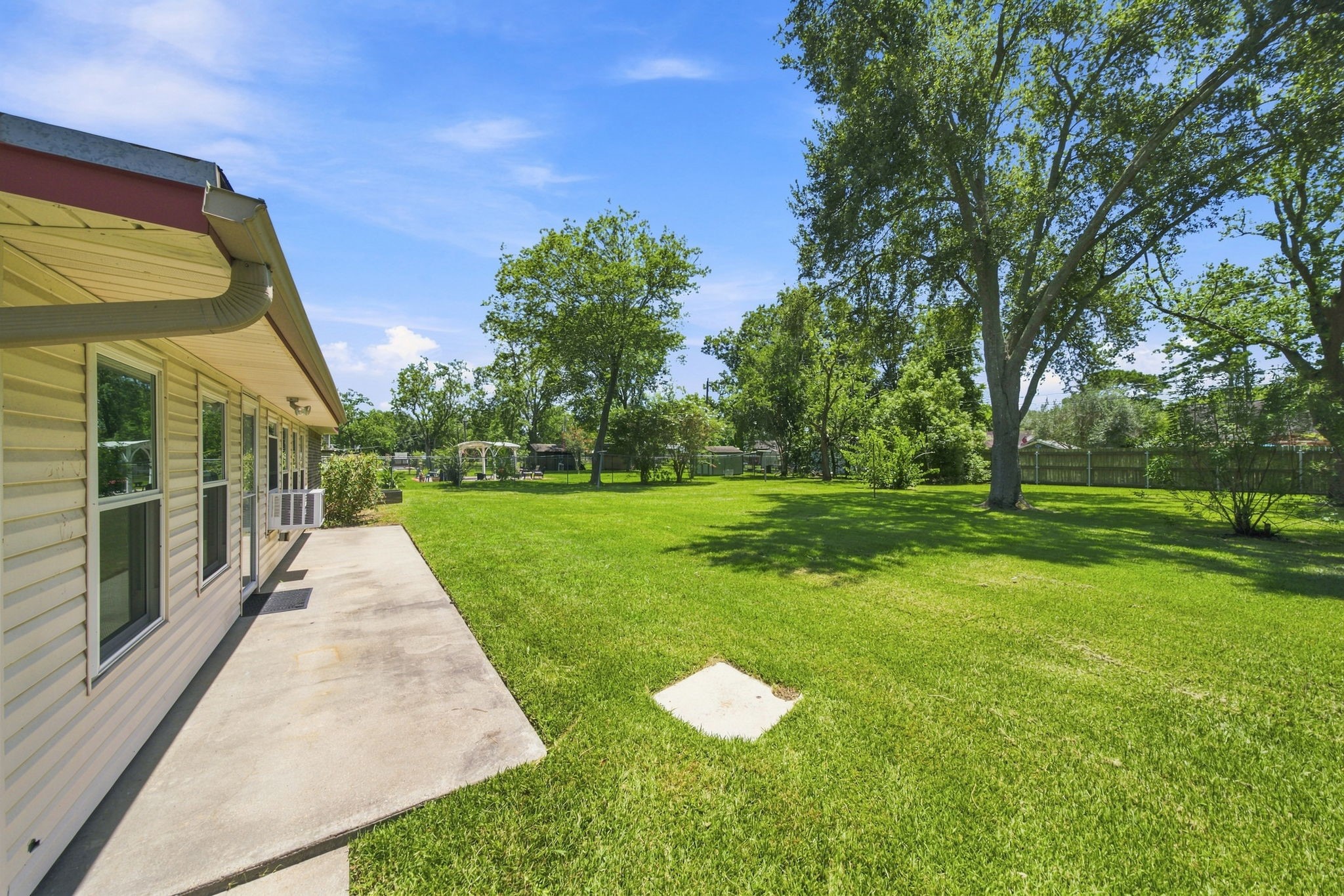Fully fenced backyard with back patio
