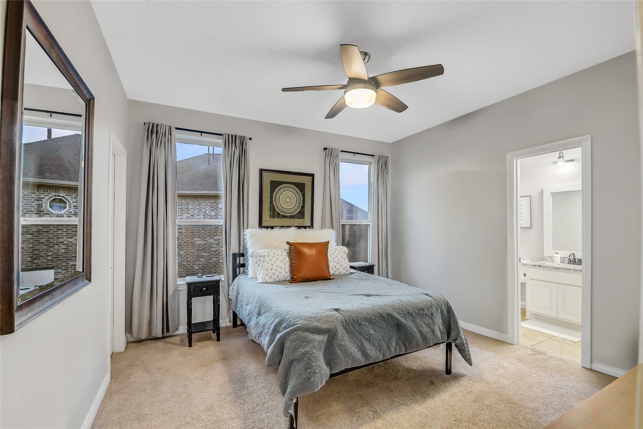 Secondary bedroom upstairs with dual windows, walk-in closet and ensuite bathroom.