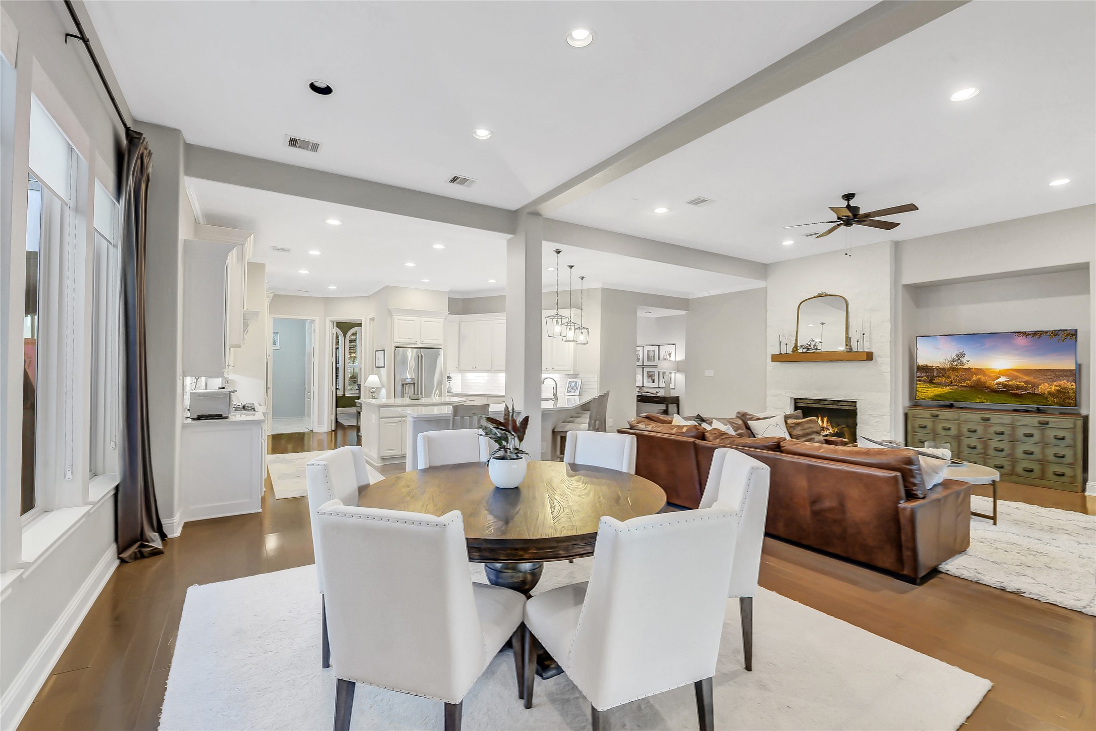 This angle beautifully showcases the seamless flow of the open-concept living, dining, and kitchen space.