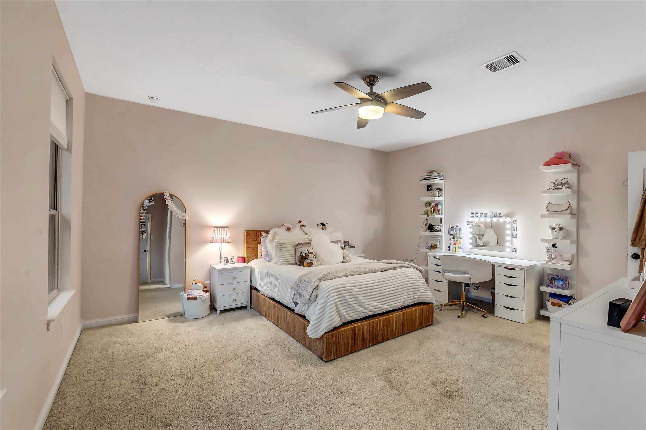 Light-filled upstairs bedroom with ample room for a sitting area or study space, plus a private ensuite bath.