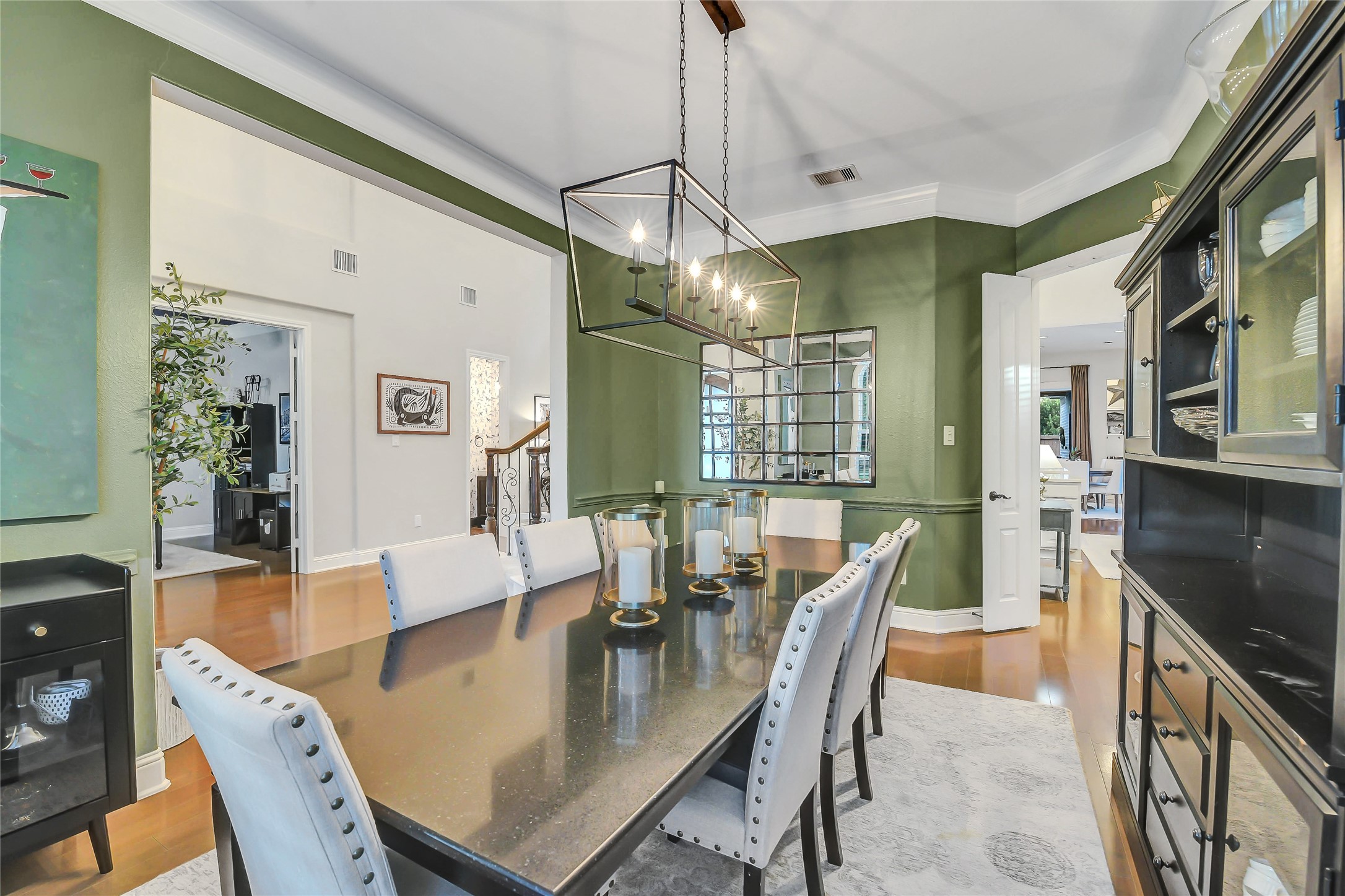 Formal dining room open to the grand entryway and seamlessly connected to the gourmet kitchen through elegant double doors.