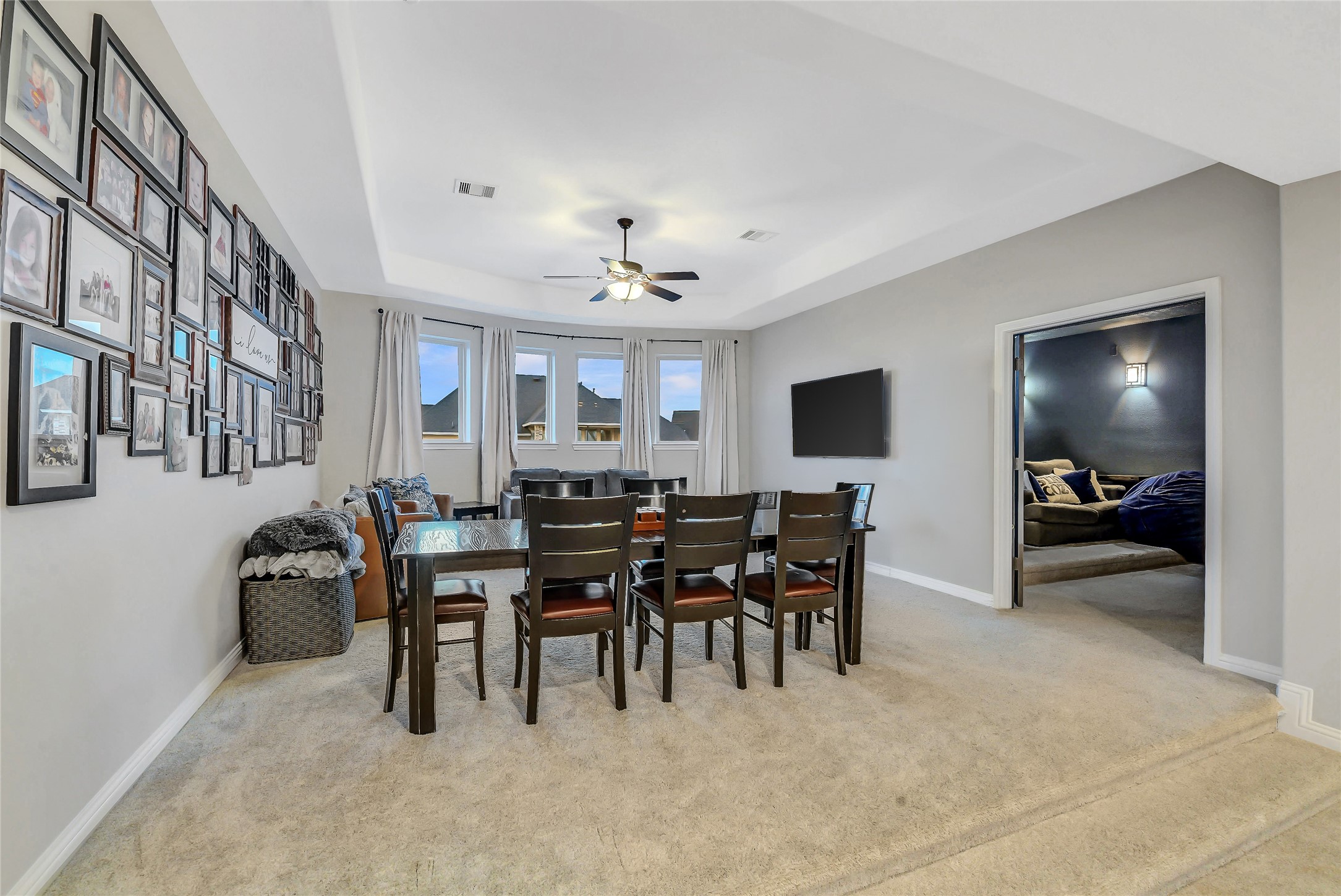 Spacious game room with elegant ceilings and direct access to the adjoining media room.