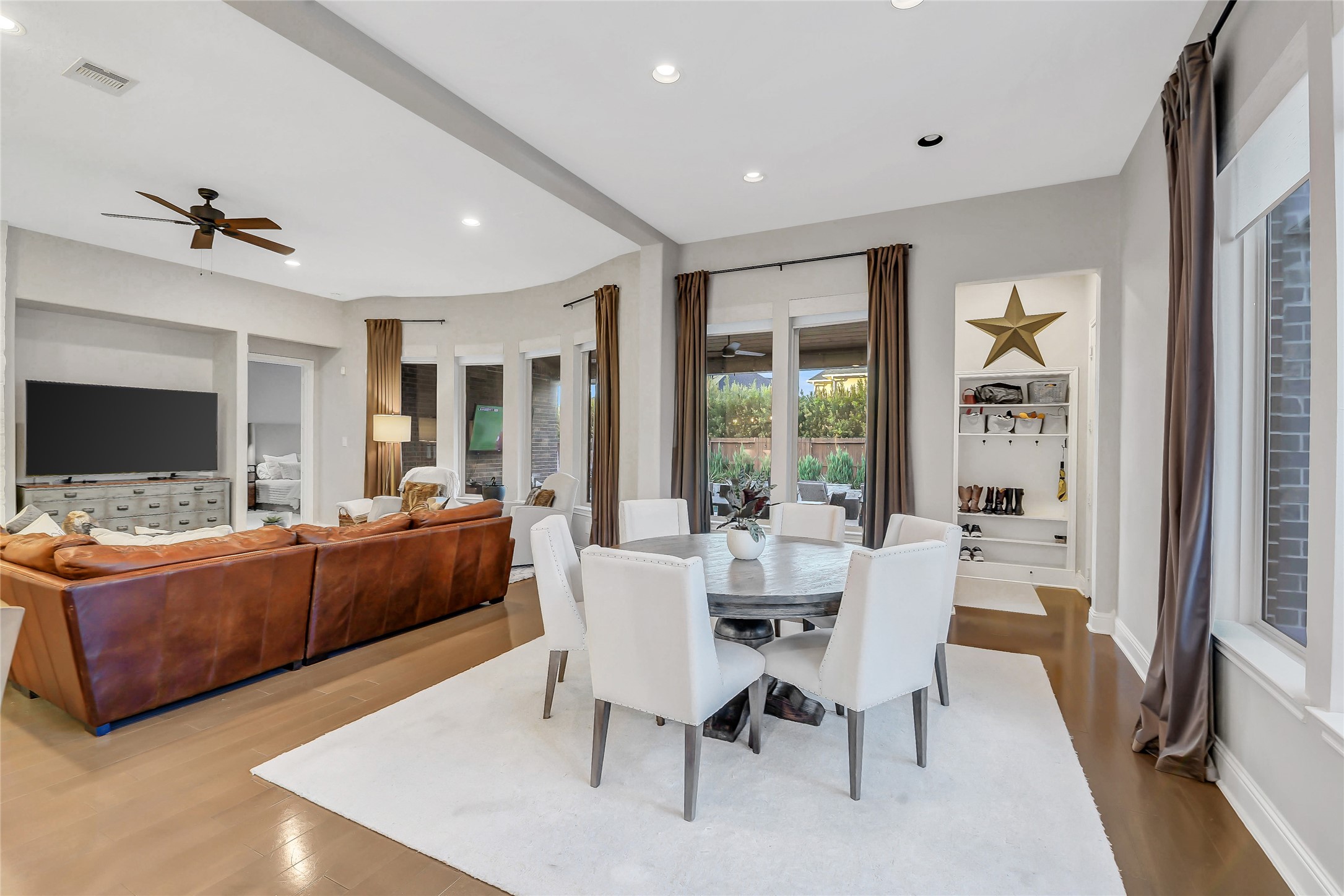 The expansive breakfast area seamlessly connects the chef's kitchen and inviting family room, creating an ideal space for casual dining and everyday living. Convenient Mudroom provides access to the outdoor living area and the attached garage, enhancing the home's thoughtful and functional layout.