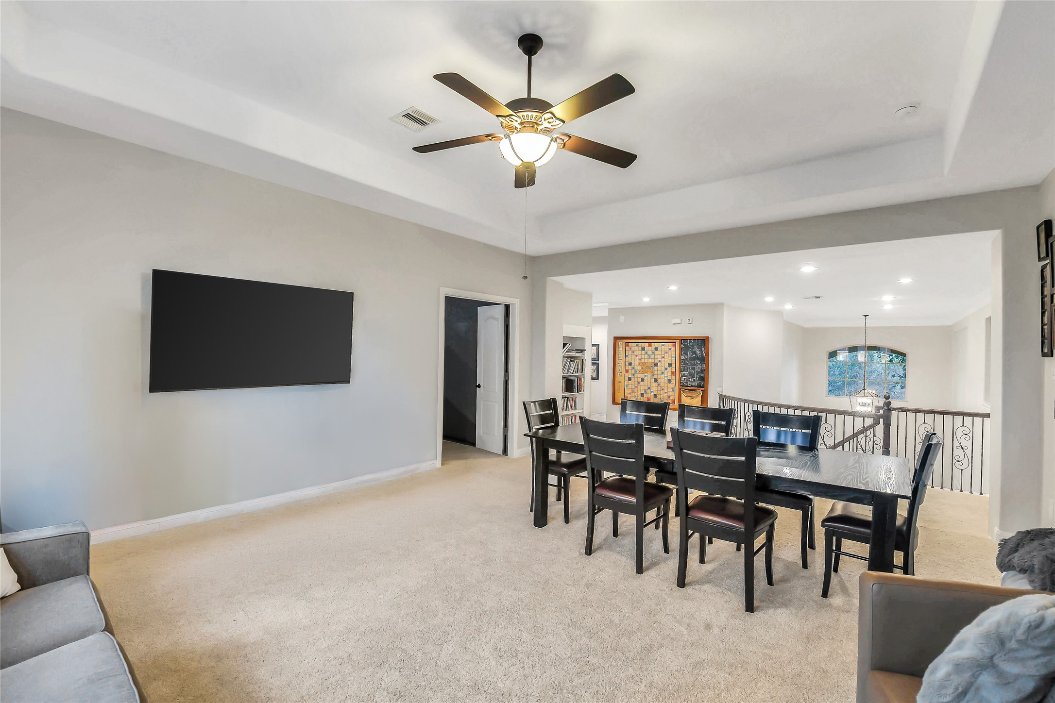 Oversized upstairs game room with abundant natural light and room for a pool table, game tables, or lounge area.