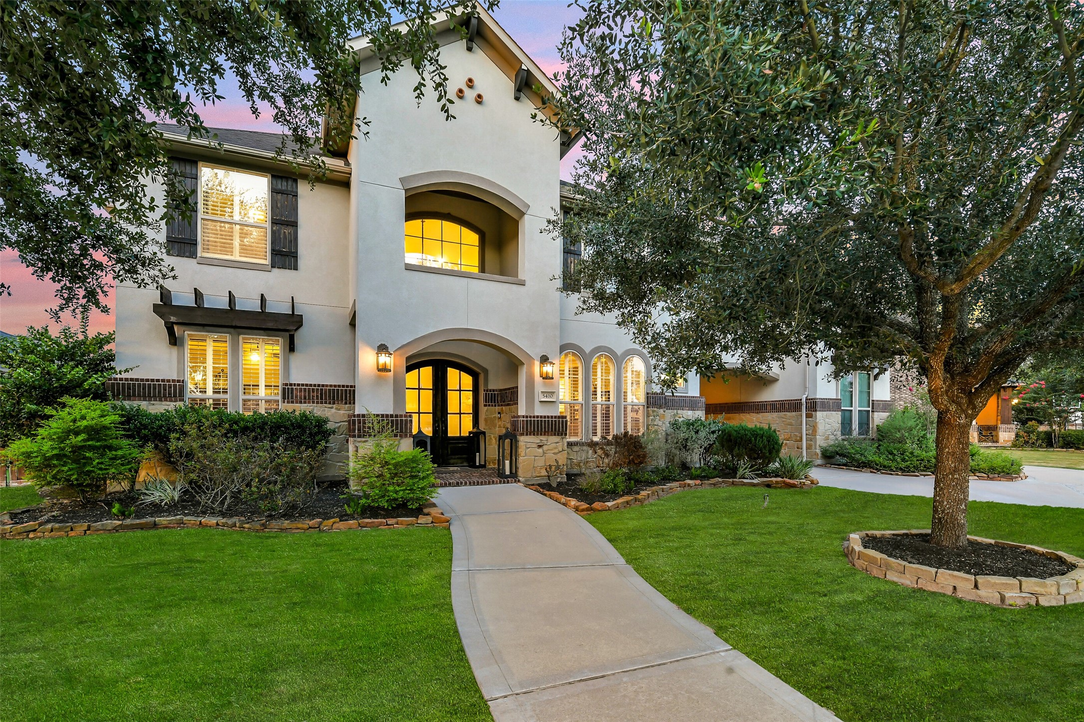 Nestled in the highly sought-after section of Iris Lake, this beautiful home features a timeless stucco and stone exterior with exceptional curb appeal. An inviting walkway leads to elegant double doors, creating a warm and welcoming entrance.