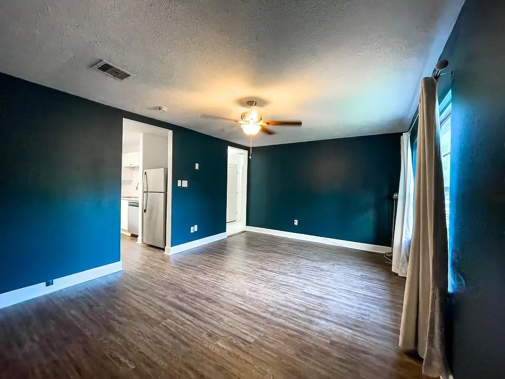 Open Living Area with Accent Wall and Wood-Look Flooring