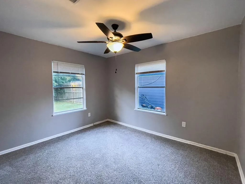 Bedroom with Ceiling Fan and Bright Window