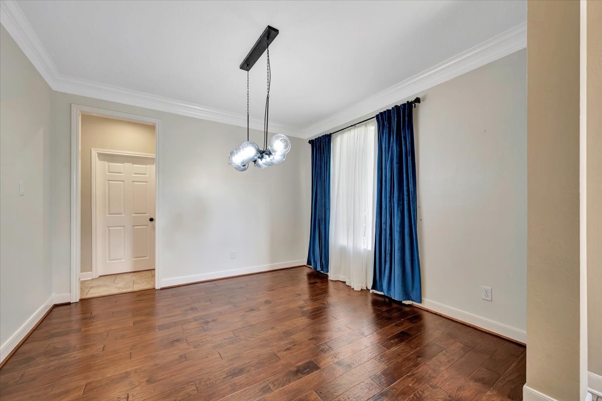Formal dining room with a chandelier and abundant natural light. Located at the front of the house.