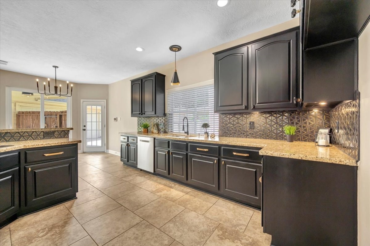 Kitchen view highlighting the generous counter space and breakfast bar. Kitchen view highlighting the generous counter space and breakfast bar.