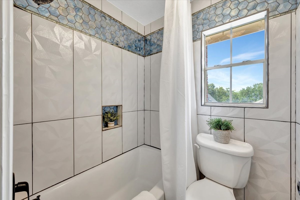 This bathroom has a separate shower and an toilet enclosed  area, adding convenience and functionality.
