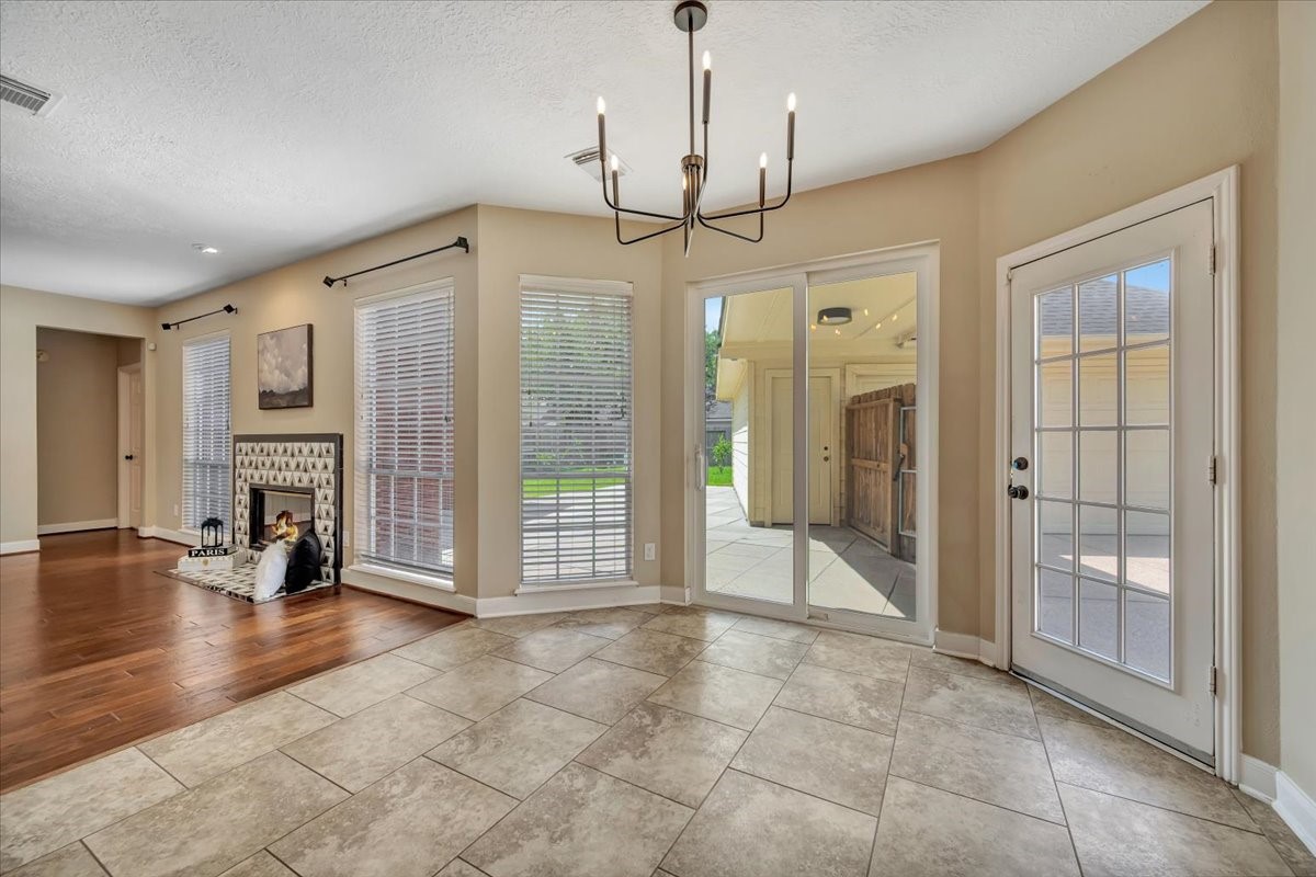Breakfast area with room for casual dining and recently added double doors that create a seamless transition to the backyard and outdoor living space.