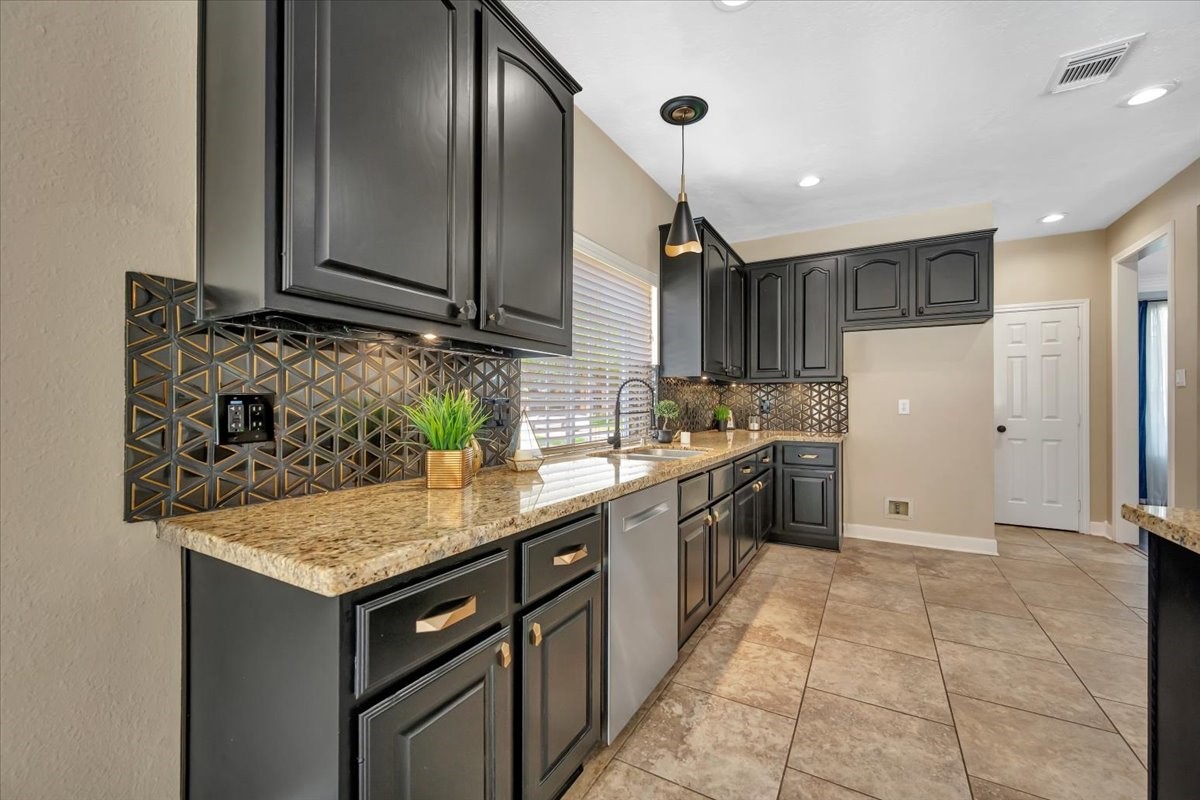 Updated kitchen with granite countertops, stainless steel appliances, and ample cabinetry. Updated kitchen with granite countertops, stainless steel appliances, and ample cabinetry.