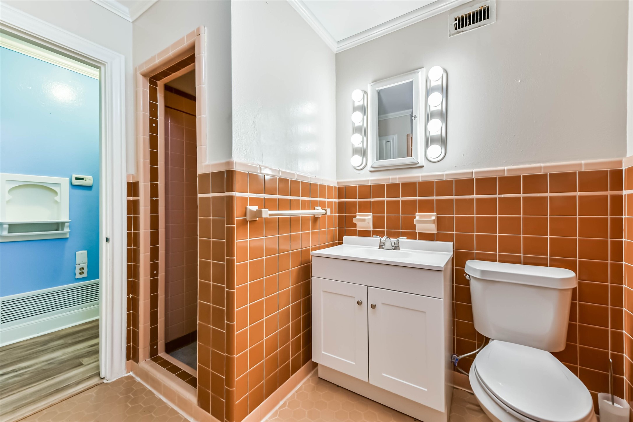 Same bathroom newer cabinet and lighting