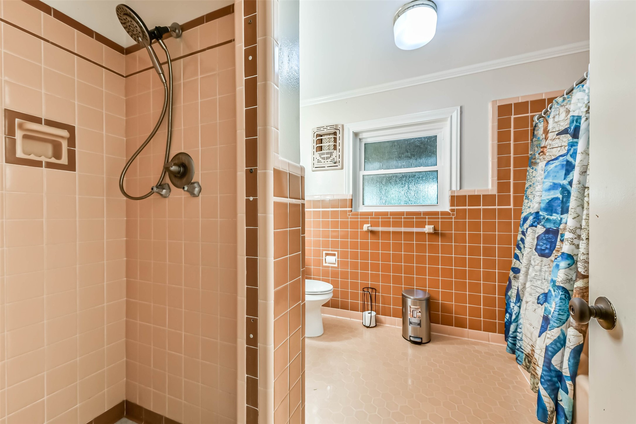 Full bath for secondary bedrooms, has a tub and separate shower.