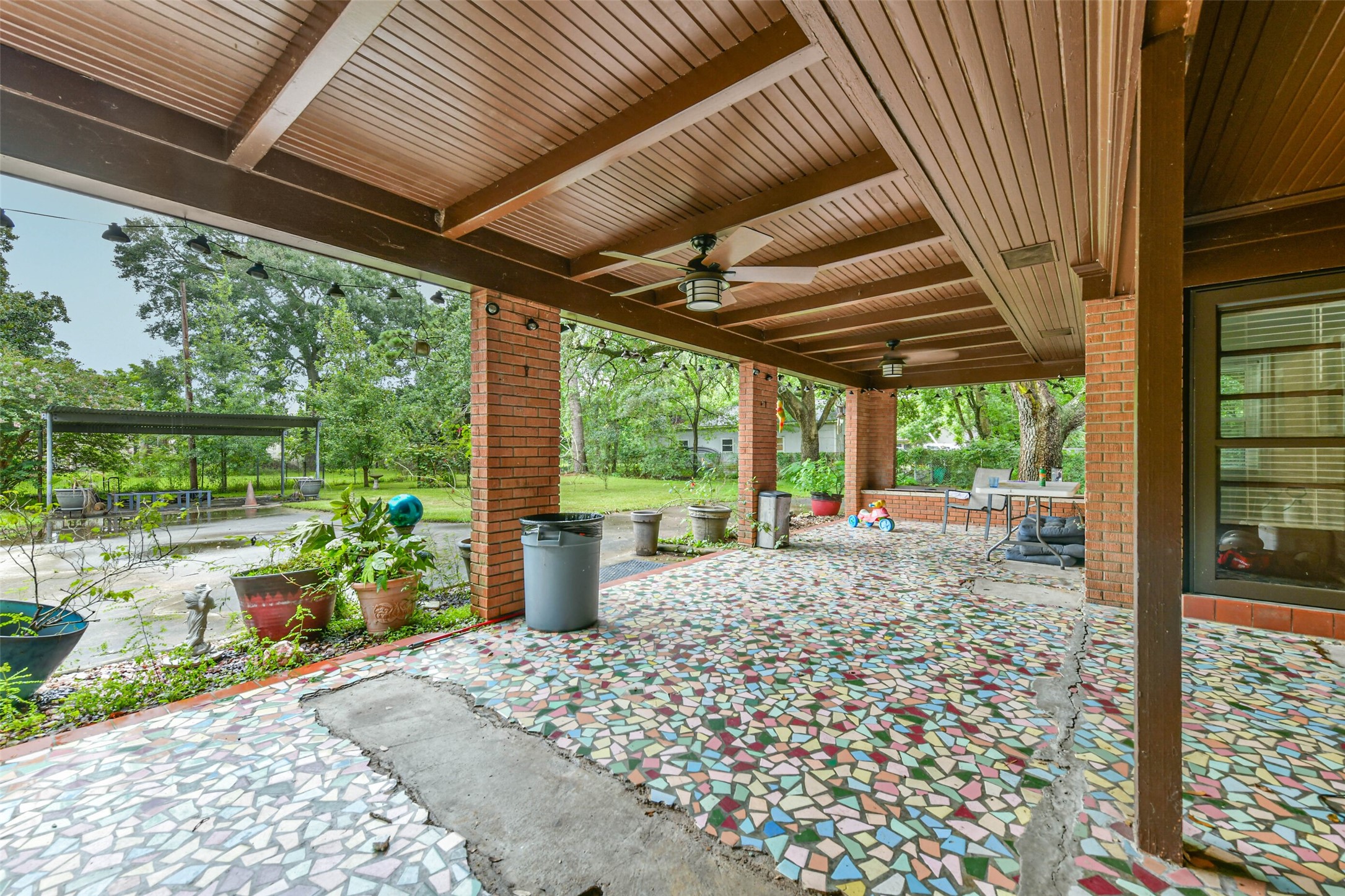 Beautiful and large covered patio, the missing tiles are from the foundation repair.  Two ceiling fans that work, room for plenty of furniture for gatherings