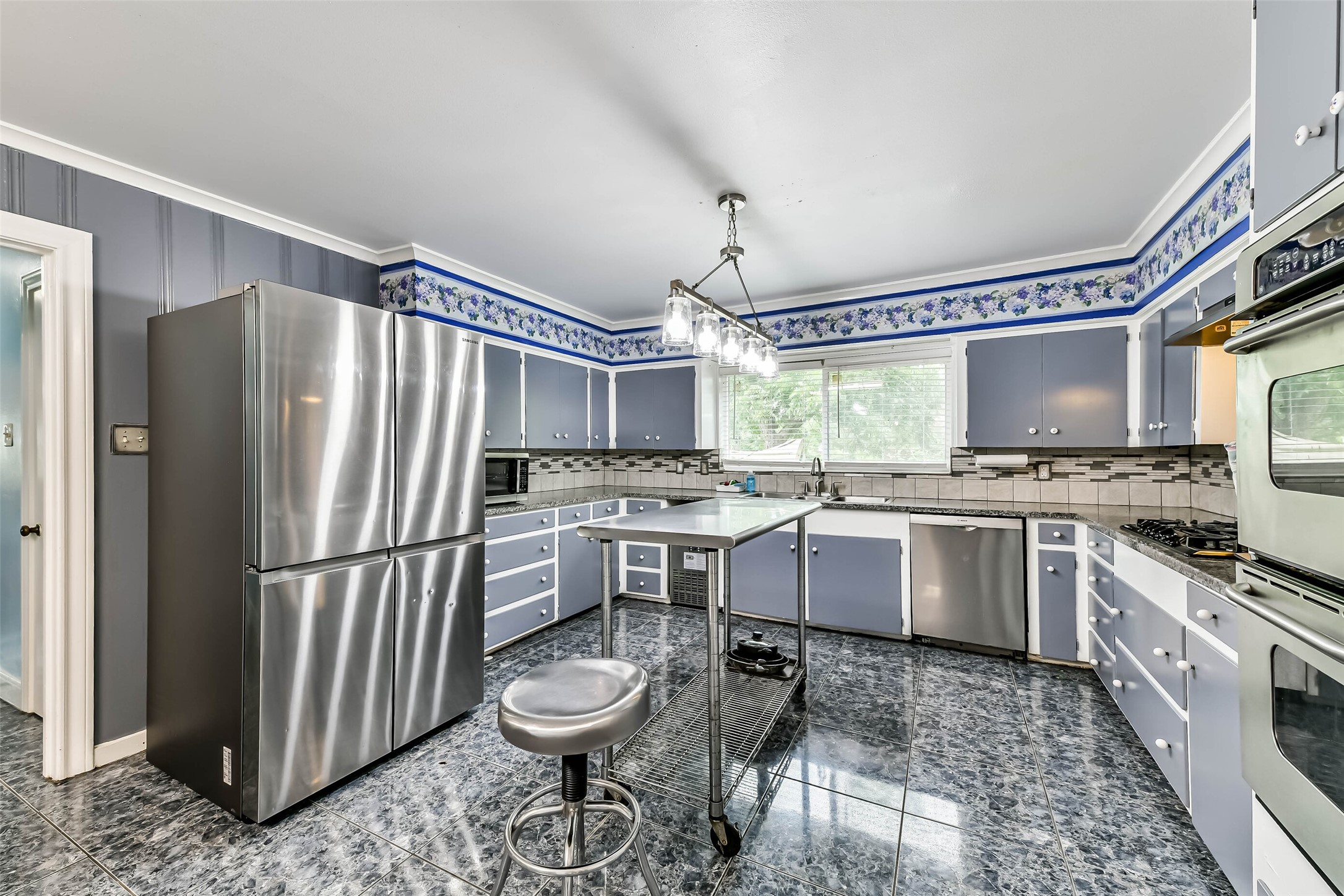 Lots of counter space and tons of storage.  Large tile flooring, all appliances stay but the metal table on wheels with chair go with the seller