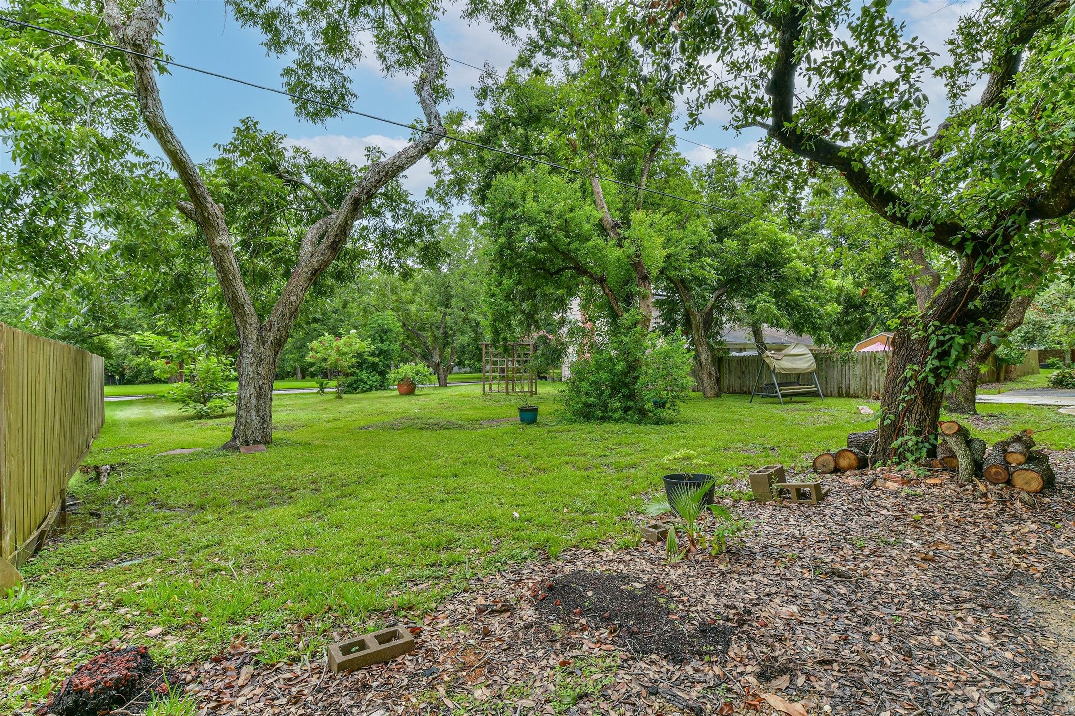 This is the extra lot that puts the lot size over an acre.  Has 4 established producing pecan trees.  Lot is on Estates Drive and could be sold, used to put in a nice pool or build another garage.  So much potential still with this property.