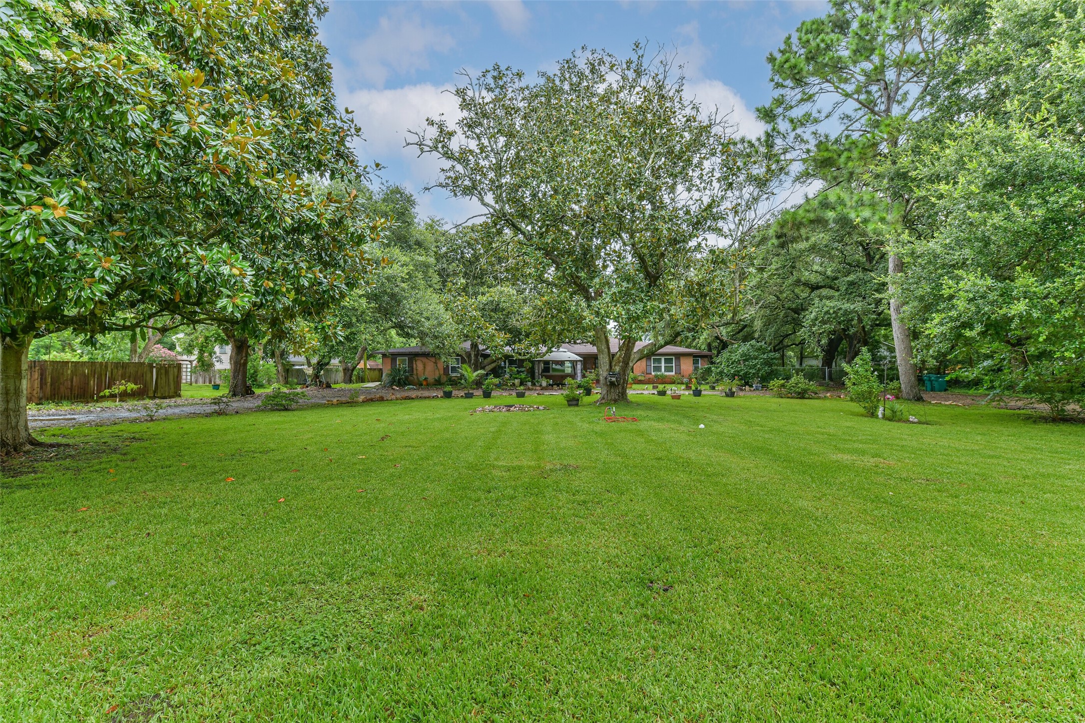 Standing in the front of the lawn looking towards the house.  House sits at the back of the lot for privacy and plenty of yard for Easter, family gatherings and room for adding anything you want