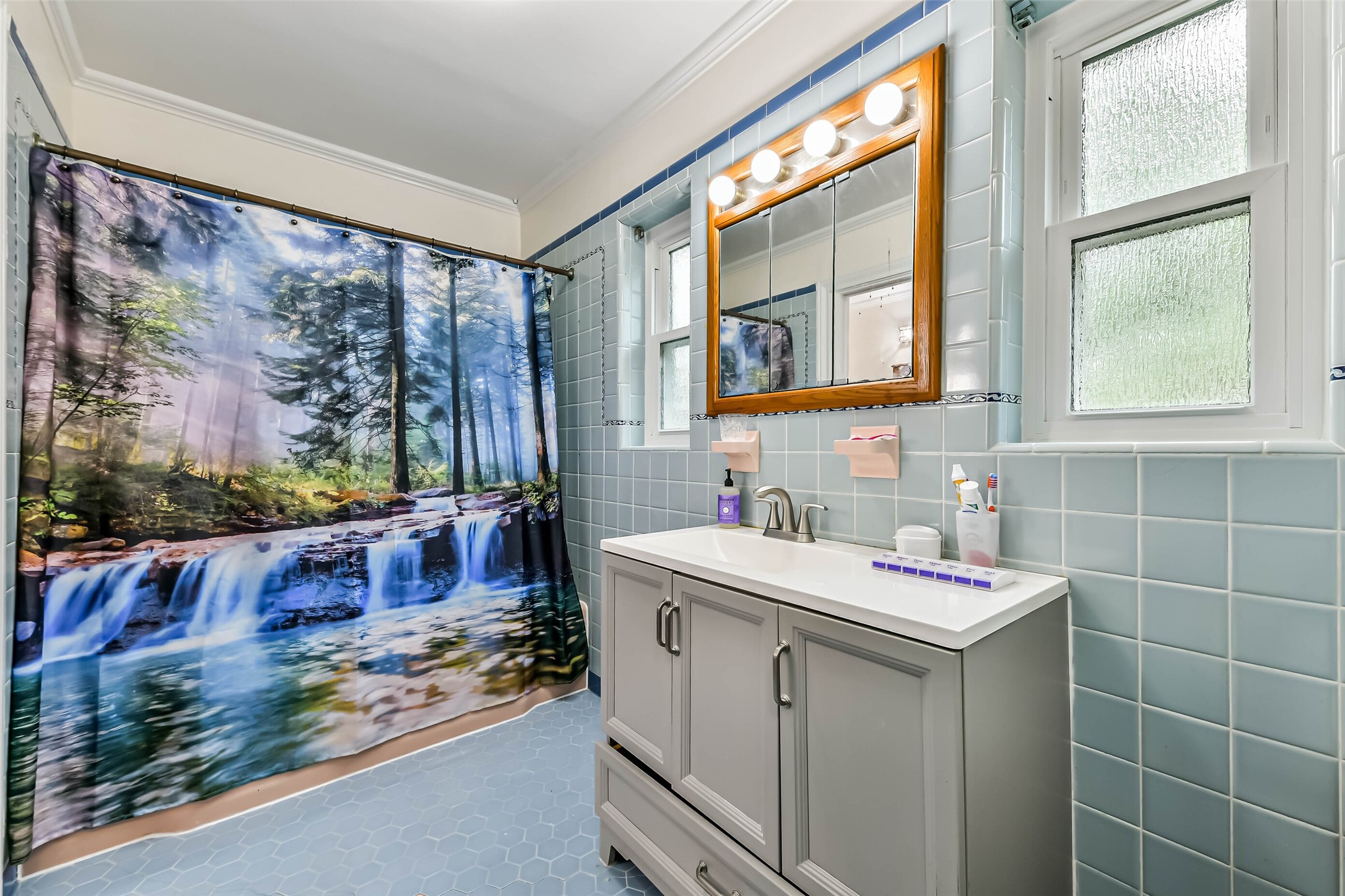 Master bathroom with tub and shower.  Large newer cabinet, new windows!