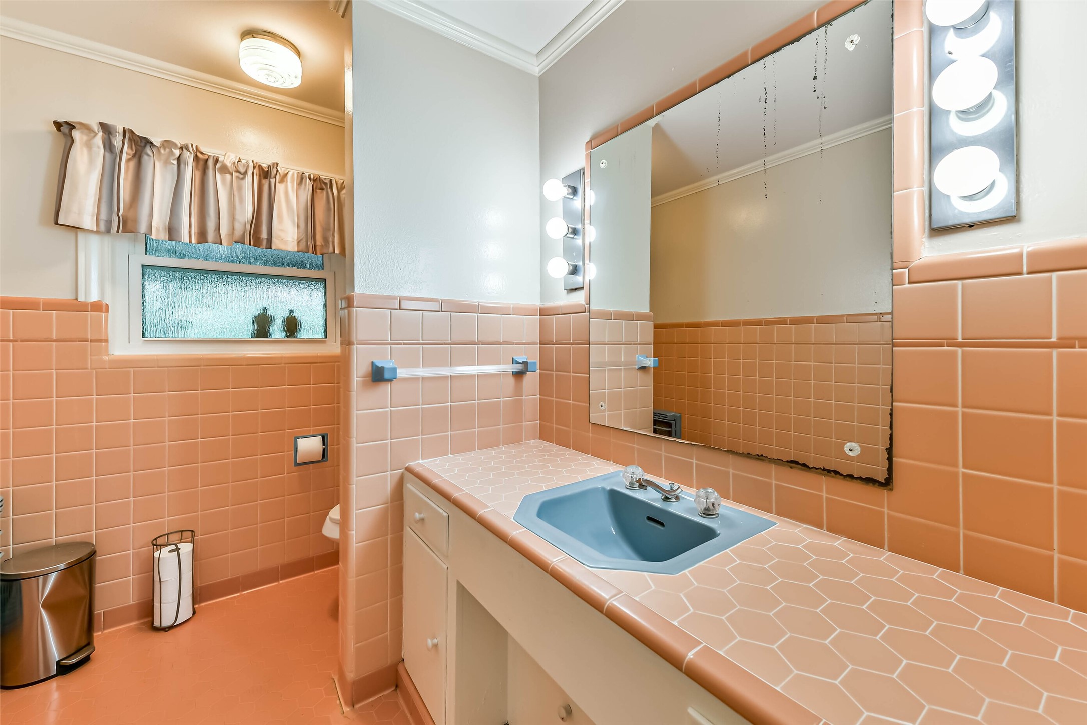 In the same hallway and right next to each other is an additional half bath with double vanity, storage, and toiler.  Mirror is being replaced just didn't get it done in time before pictures.