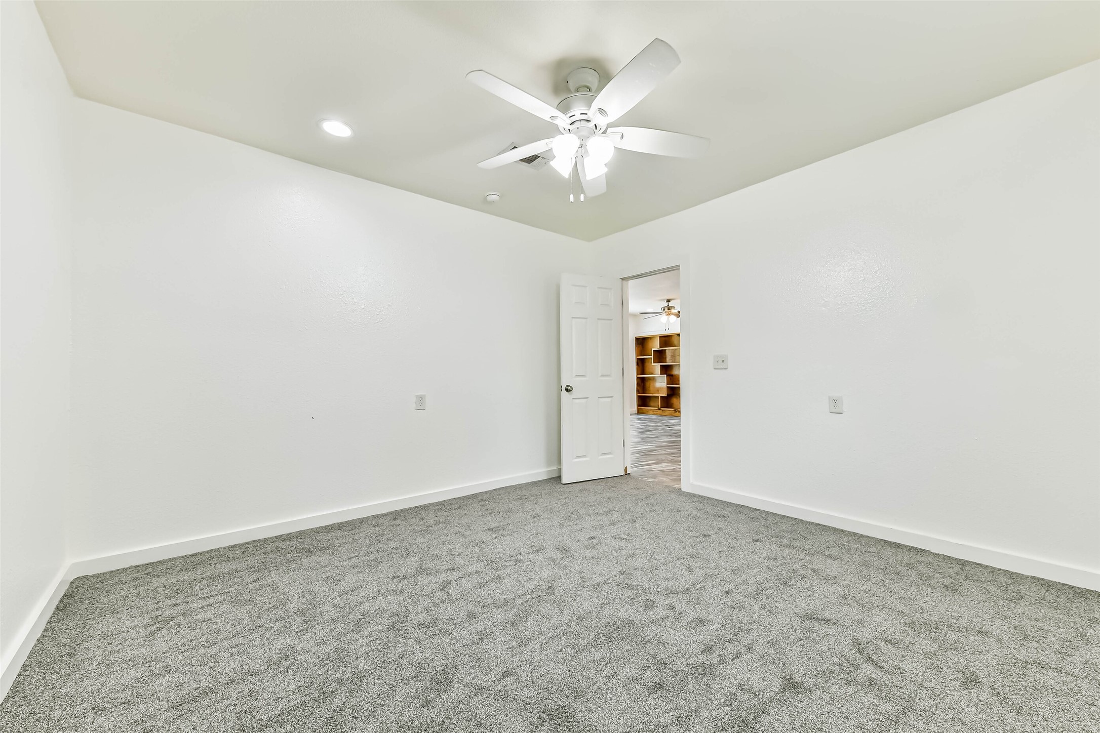 View of second bedroom in garage conversion.  Just put in brand new carpeting for the new owners