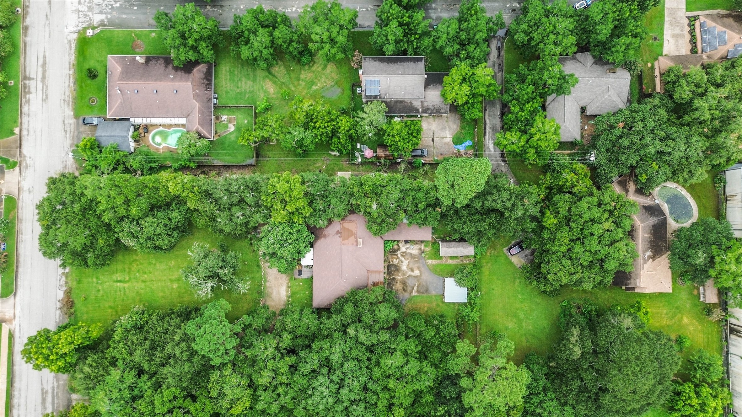 Arial view directly above the property with lot on Estates Drive and back of house