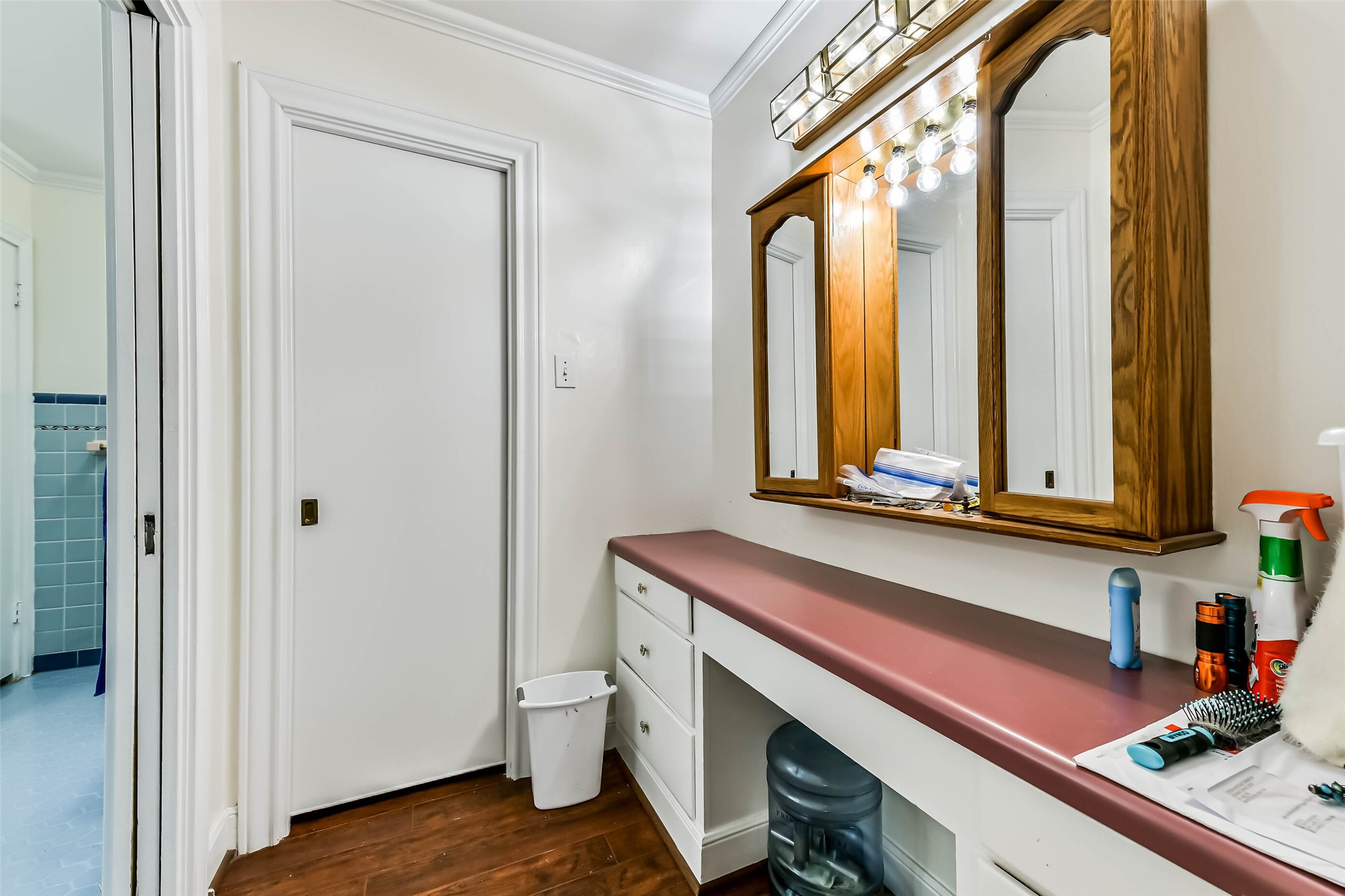 Nice long cabinet and counter for getting ready with another closet, door to left leads to the remaining master bath
