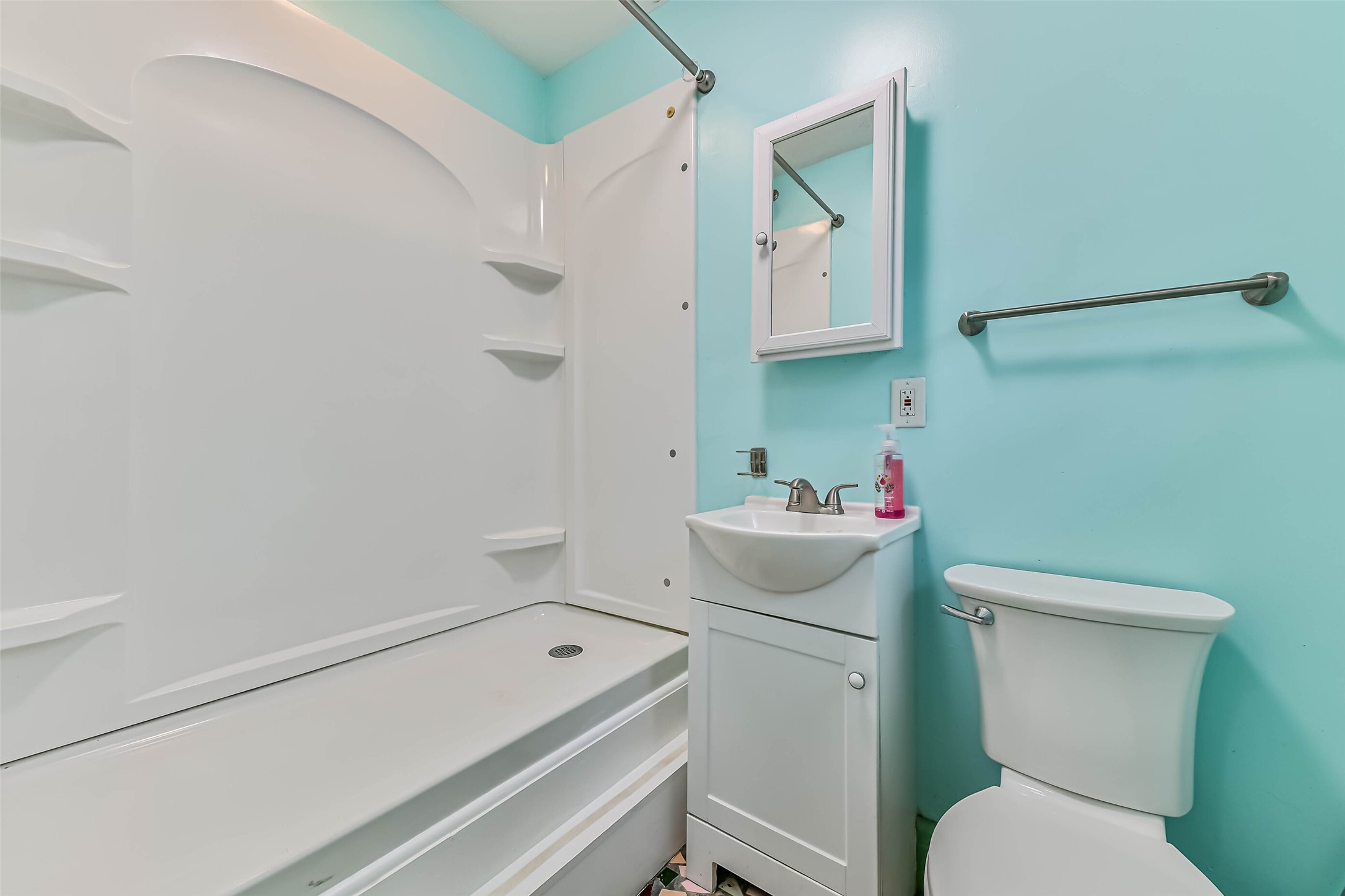 Step up shower with small sink and toilet for garage conversion.