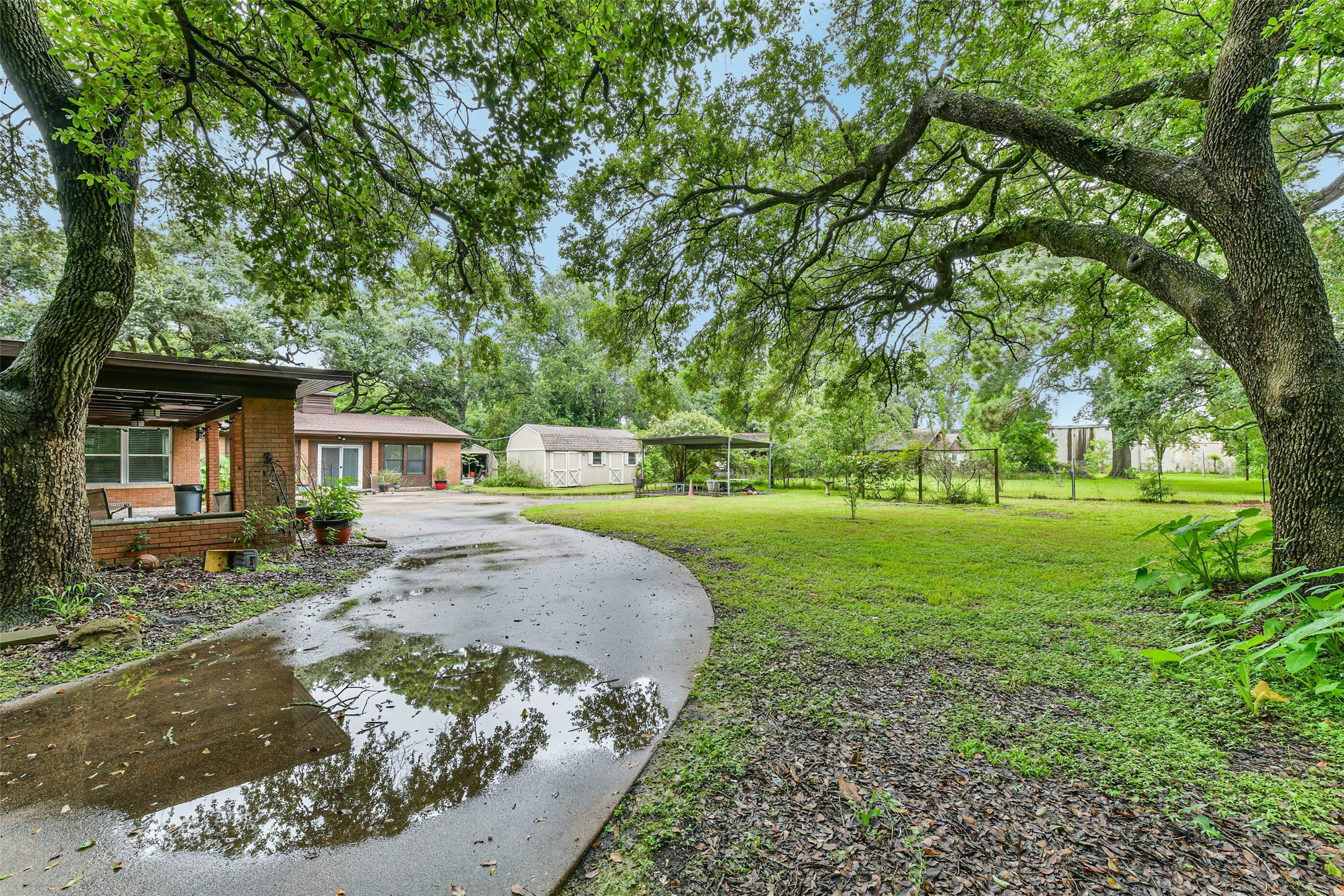 The rest of the driveway past gate leading to the carport and garage conversion.