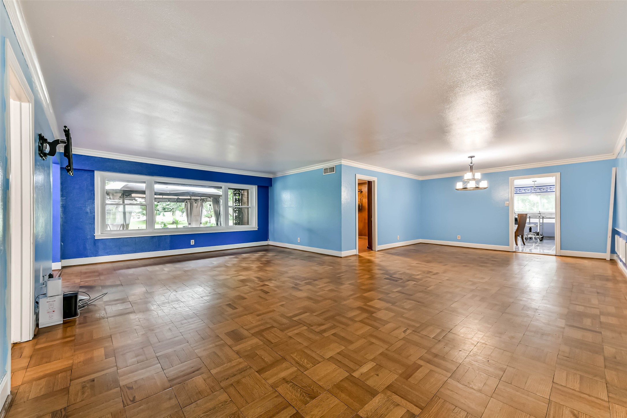 Another view of formal living and dining showing new large picture window, door left of formal dining area is the private office.  The large door on the right leads to the kitchen.