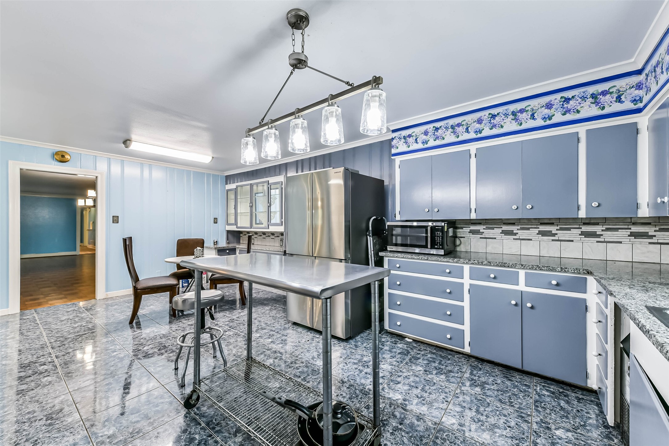 Another view of kitchen counters and backsplash, door leads to formal living and formal dining room