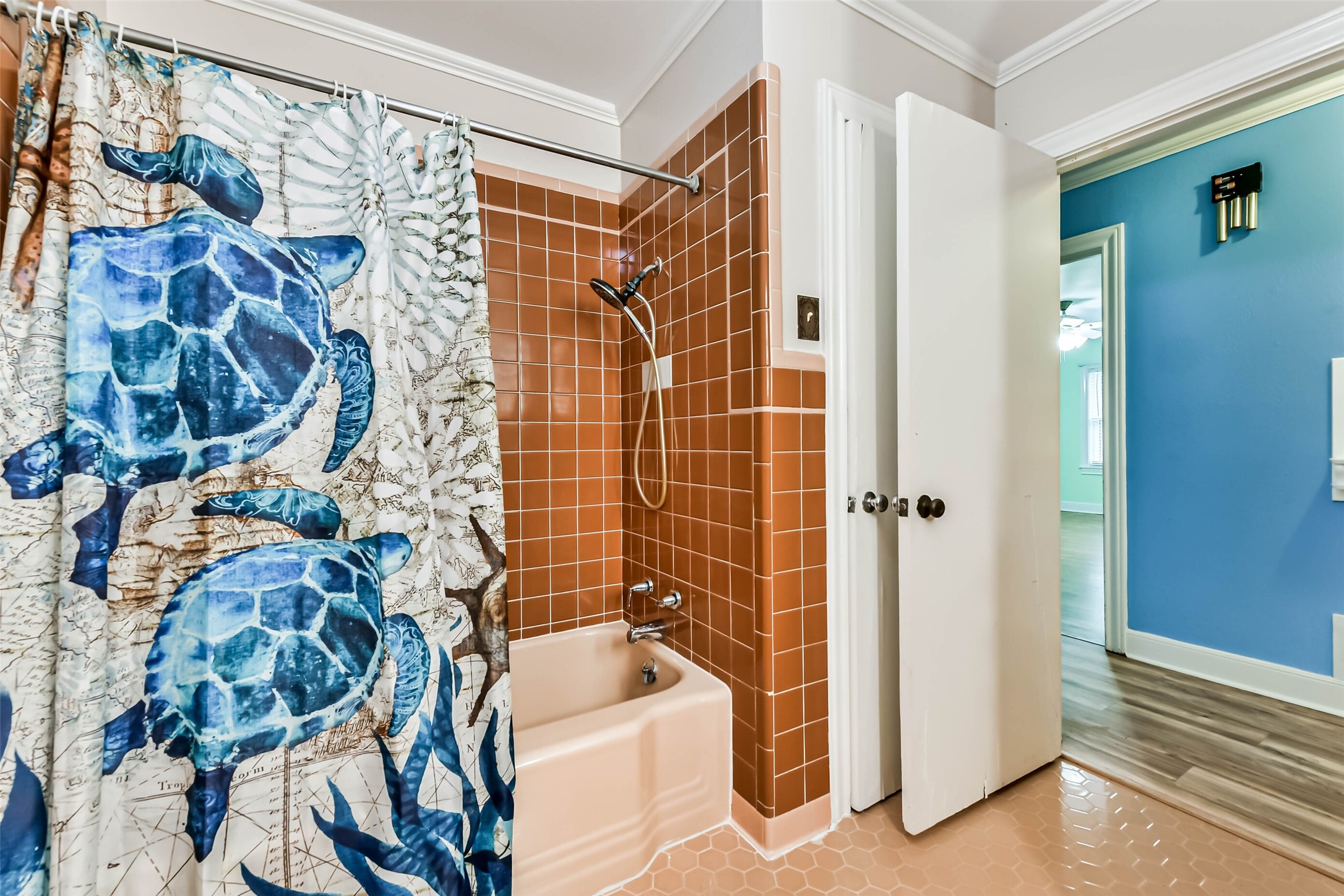 Full bath showing tub and closet behind the door.
