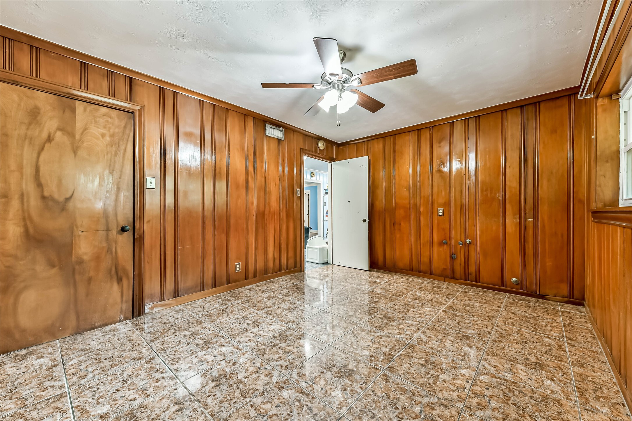 Another view of 3rd secondary bedroom, it's located just off the kitchen and between the garage conversion.  Beautiful wood paneling