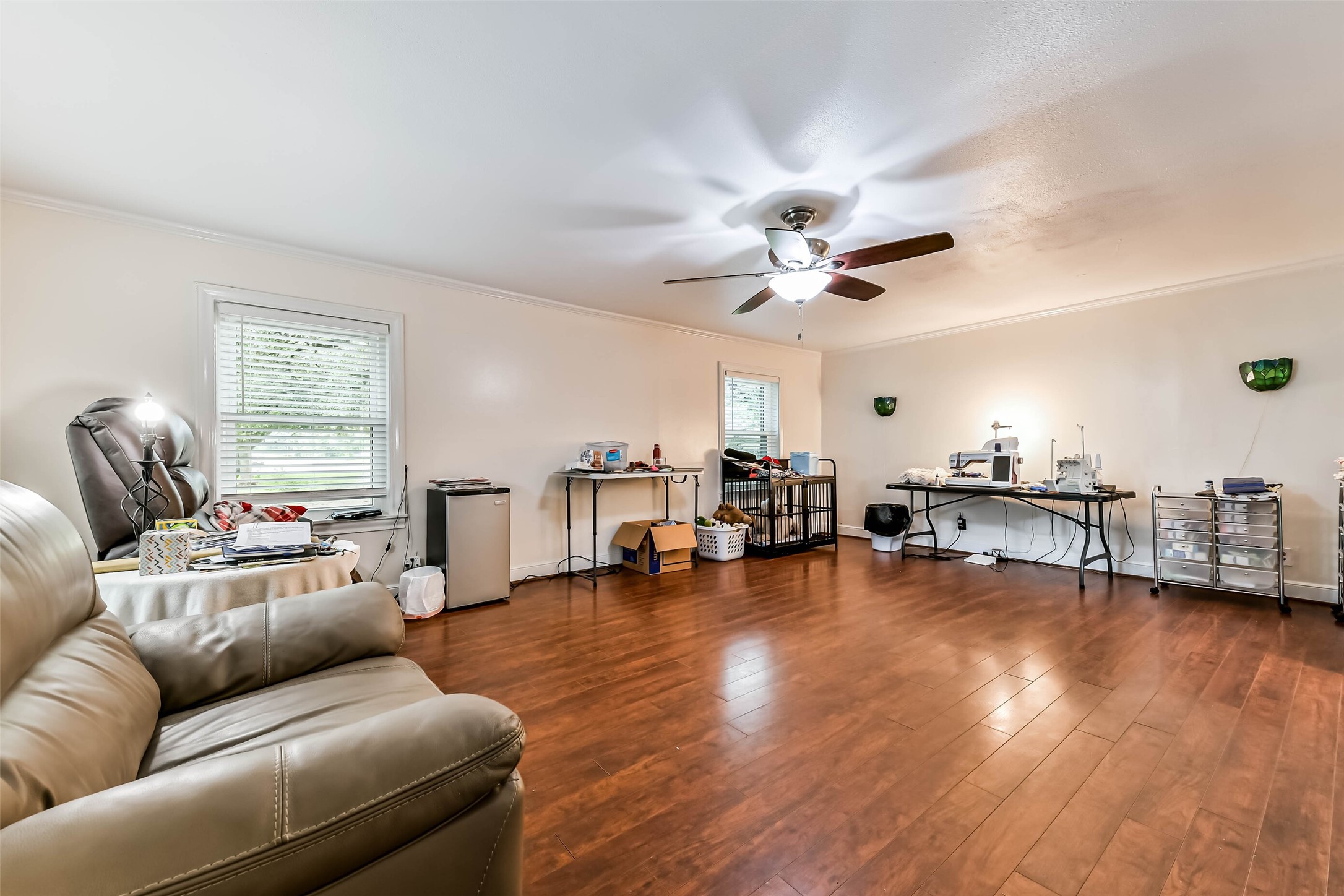 Master bedroom with seating area, wood plank flooring, new windows, numerous closets!