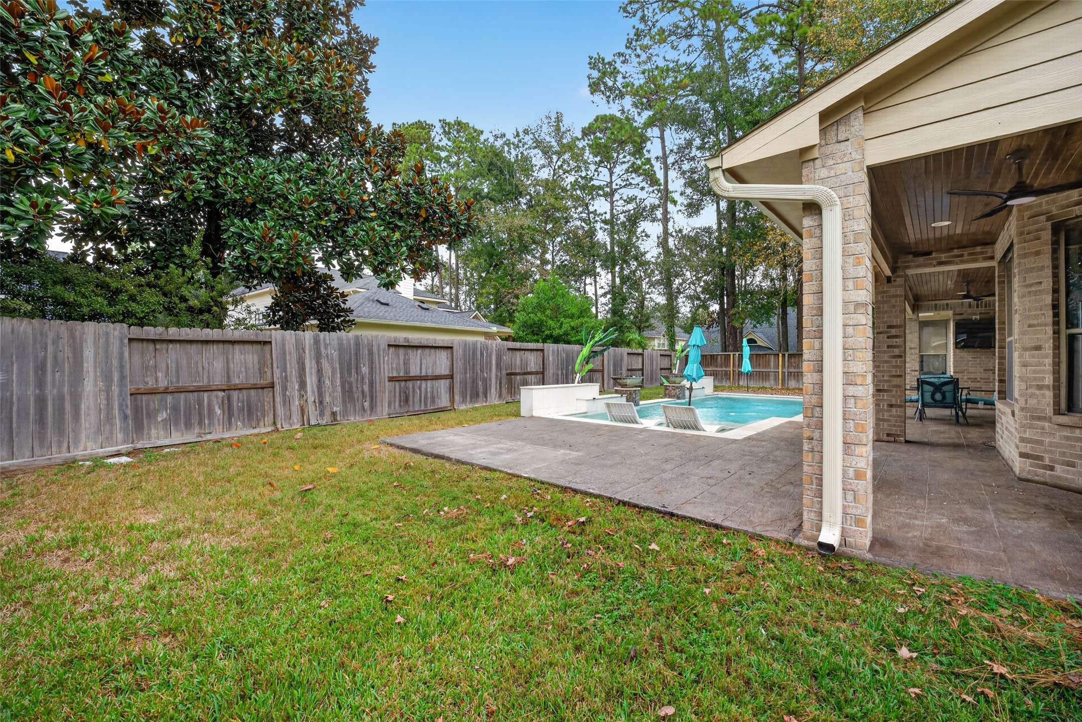 A view from the side yard with a gated entrance for lawn crews.