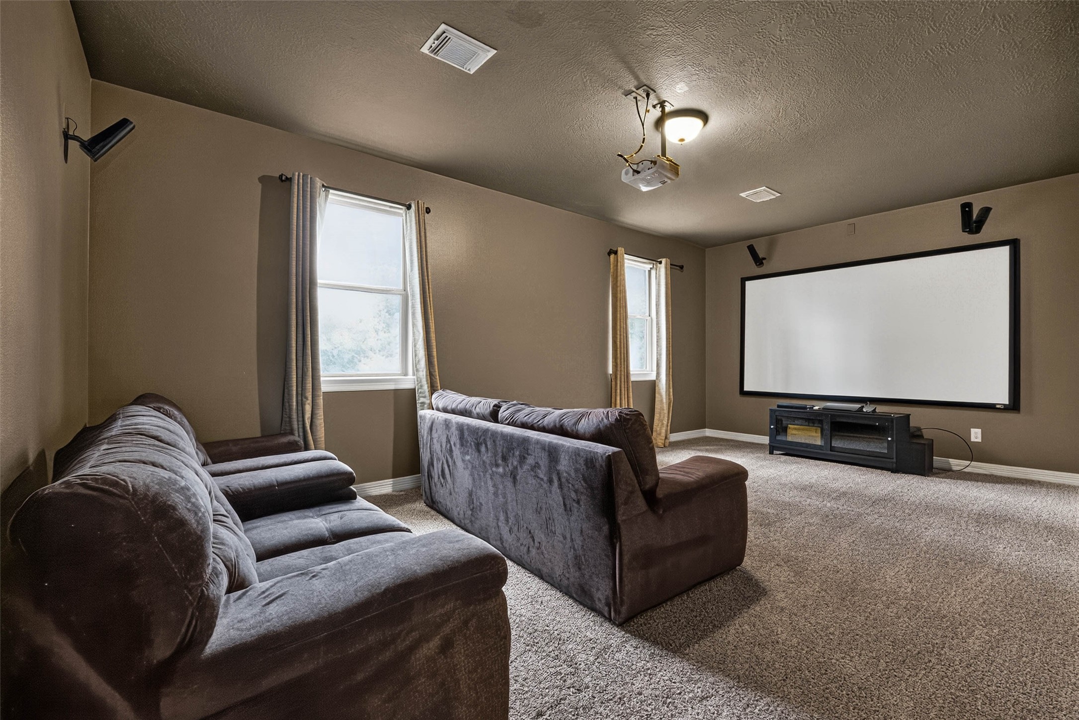 This media room large and the perfect place to enjoy movies or sports. The projector screen and equipment are included!