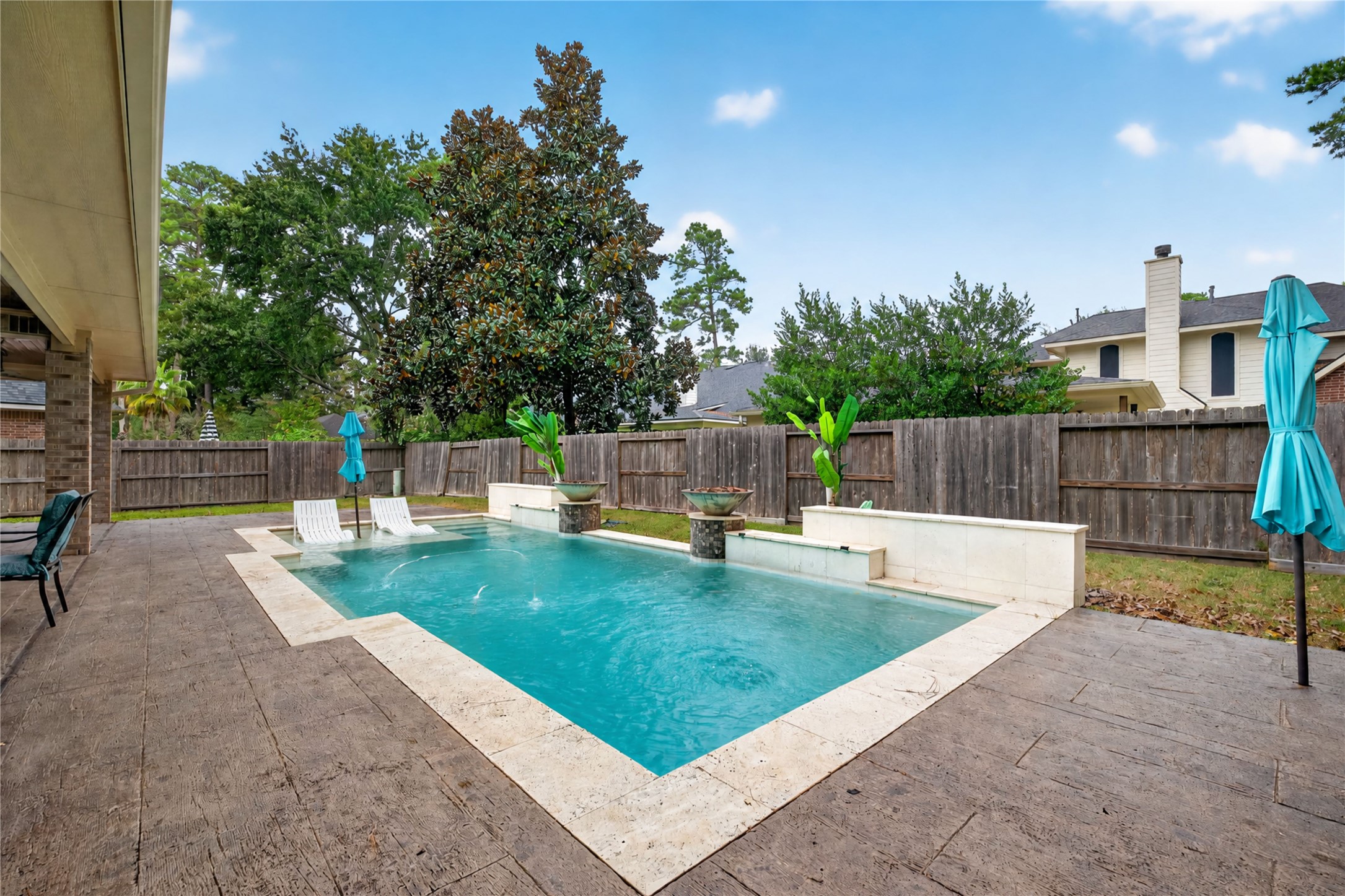 This modern pool with sun ledge is less than 10 years old.