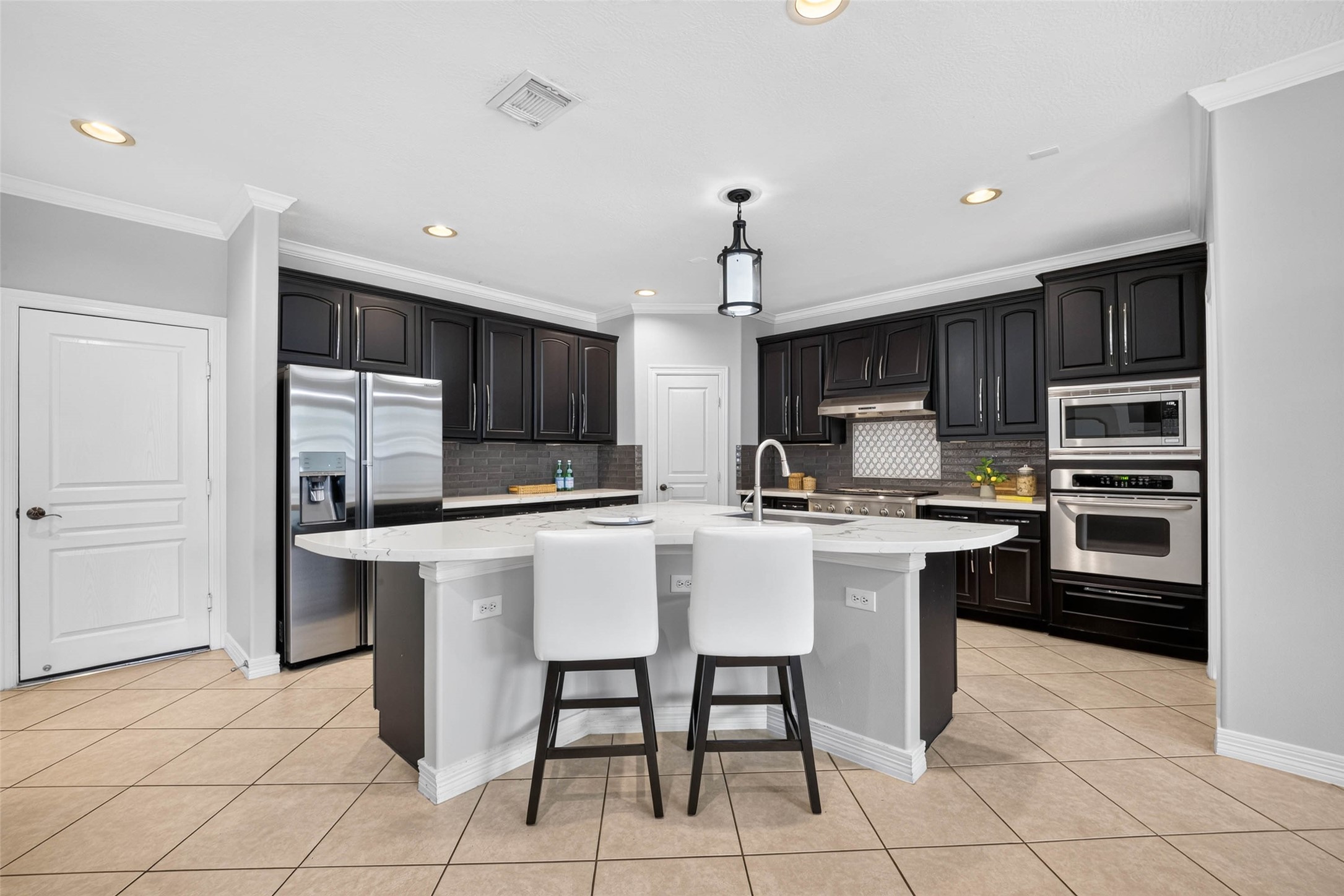 A fully updated Kitchen with Quarts counters, stainless appliances, ceramic backsplash and new fixtures.