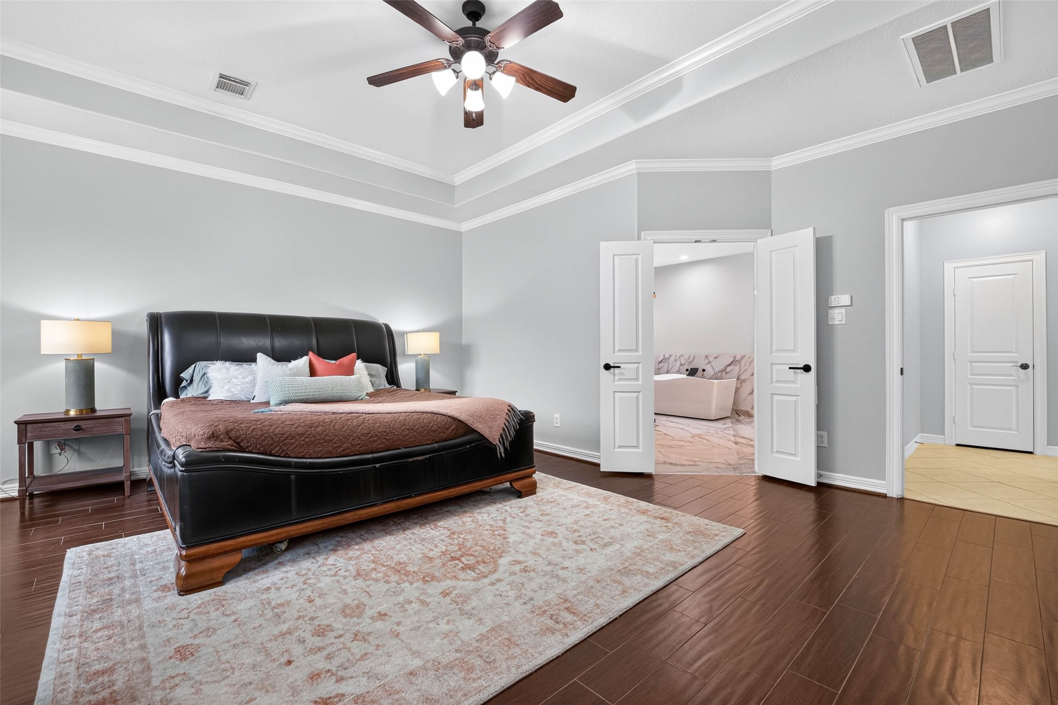 Primary Bedroom with wood-look tile flooring.