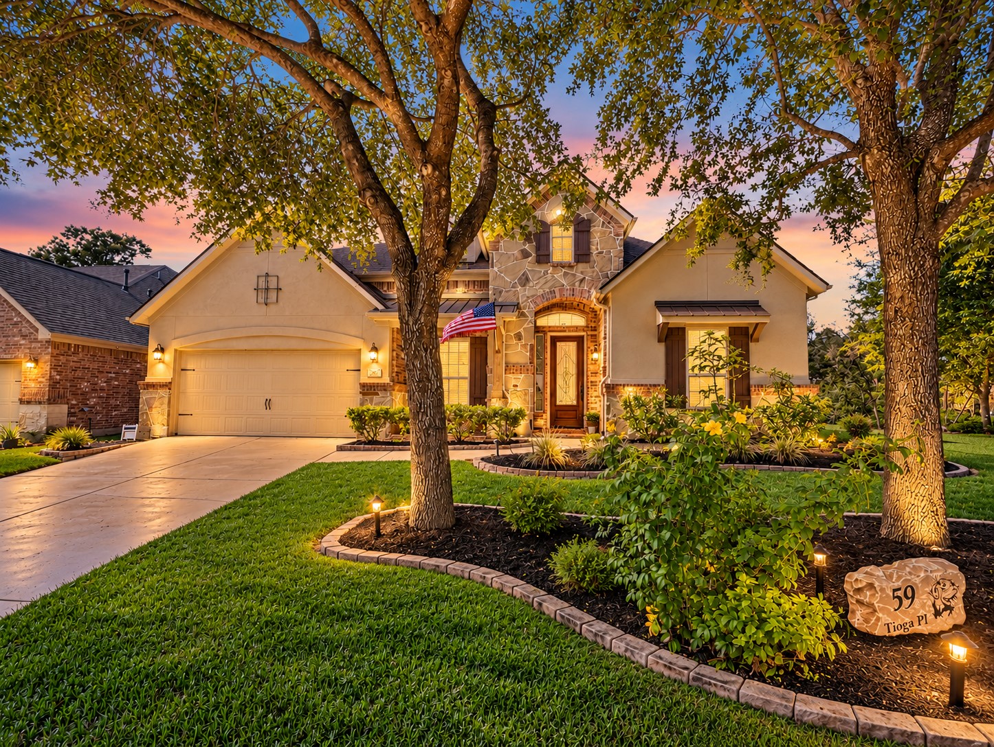 Welcome to this beautiful 1.5-story home in The Woodlands Creekside Park. Evening lighting and manicured landscaping give the home a warm, inviting presence after sunset.