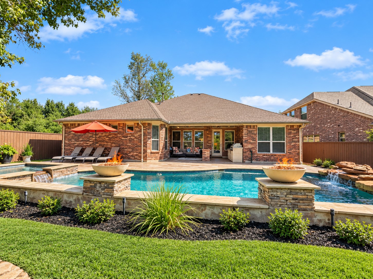 Enjoy an outdoor space where the landscaping and pool area come together to create a welcoming place to spend time outside. The rear exterior showcases the home's connection to the backyard, with windows overlooking the pool and spa and views that bring the outdoors into the main living areas.