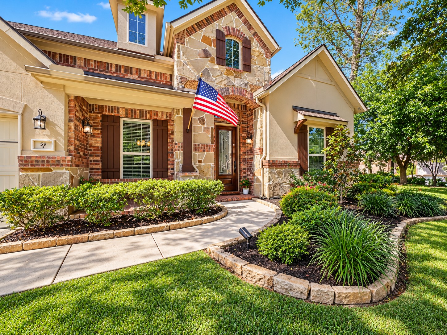 Beautifully maintained landscaping adds to the home's curb appeal, offering a warm welcome before you even step inside.