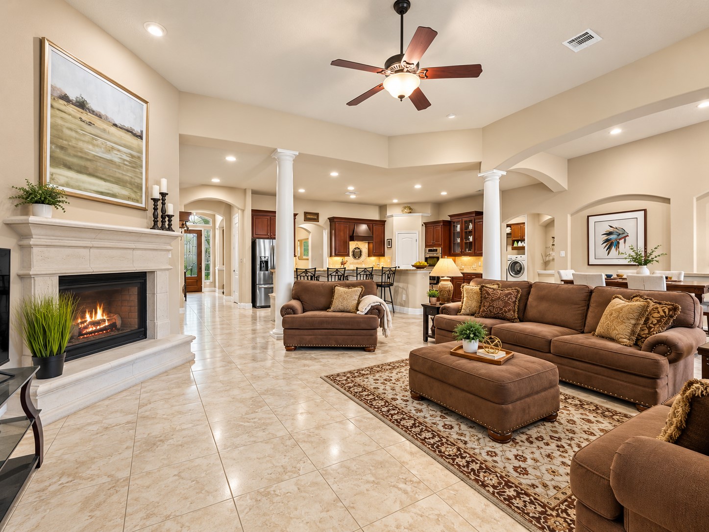 The open living space provides a comfortable setting for everyday relaxation, entertaining friends, or gathering with family. The fireplace adds a cozy focal point to the living room, creating a comfortable place to gather on cooler evenings.
