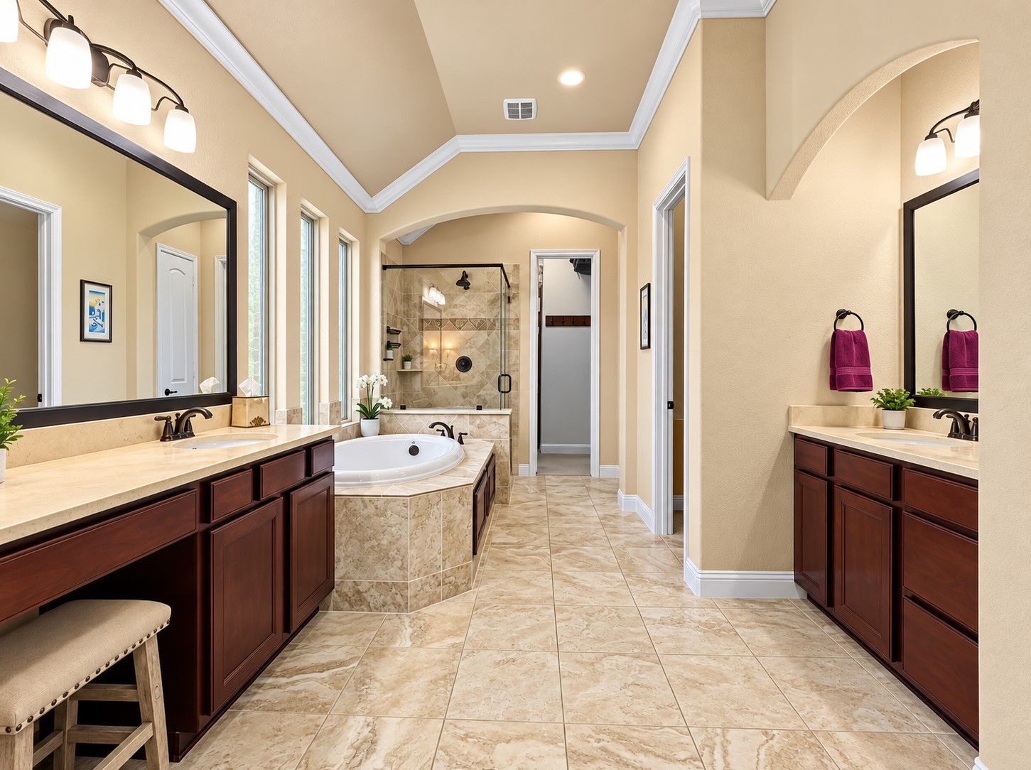 The spacious primary bathroom features dual sinks, a vanity area, a large soaking tub, and a separate shower for a comfortable daily routine.